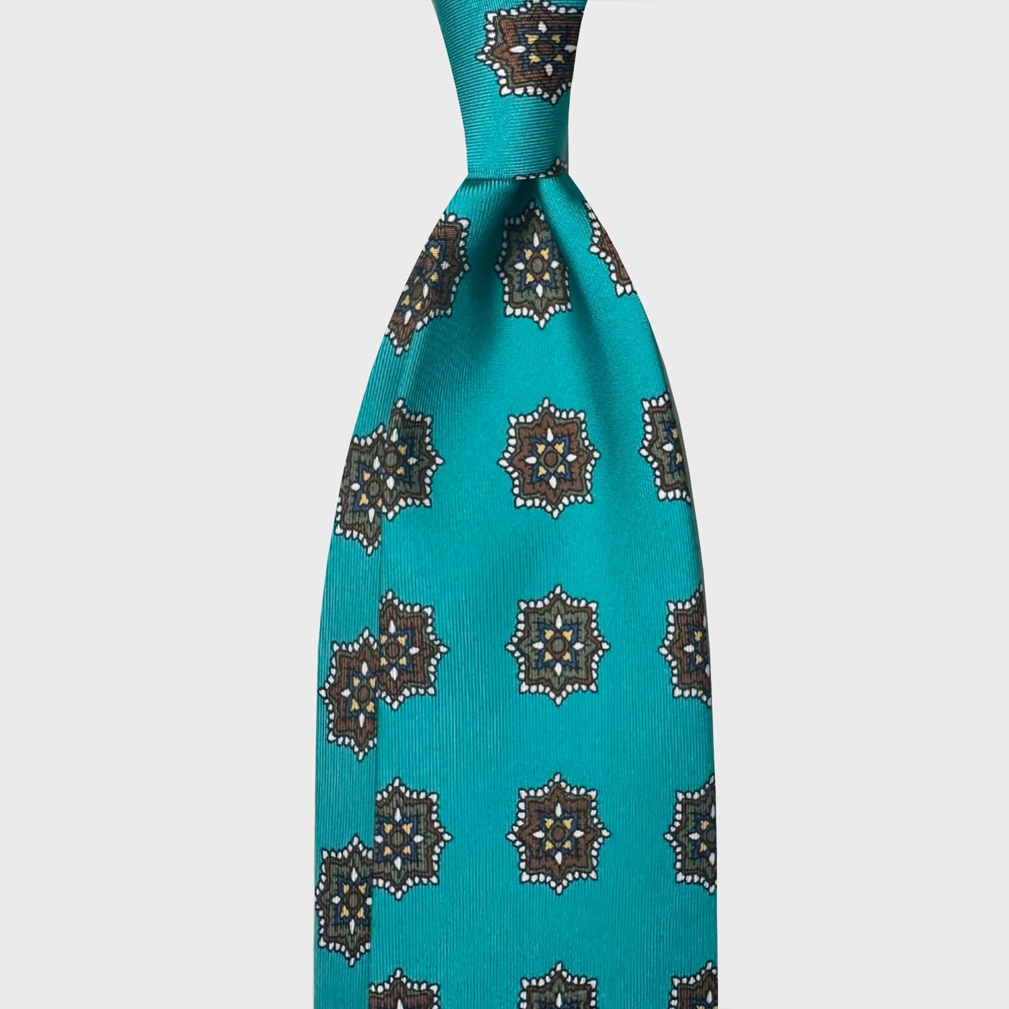 Turquoise Silk Tie Medallions Pattern Shop Geneva. Elegant turquoise silk tie, exclusive handmade in Italy Wools Boutique Uomo Geneva, turquoise background with brown and army green medallions pattern