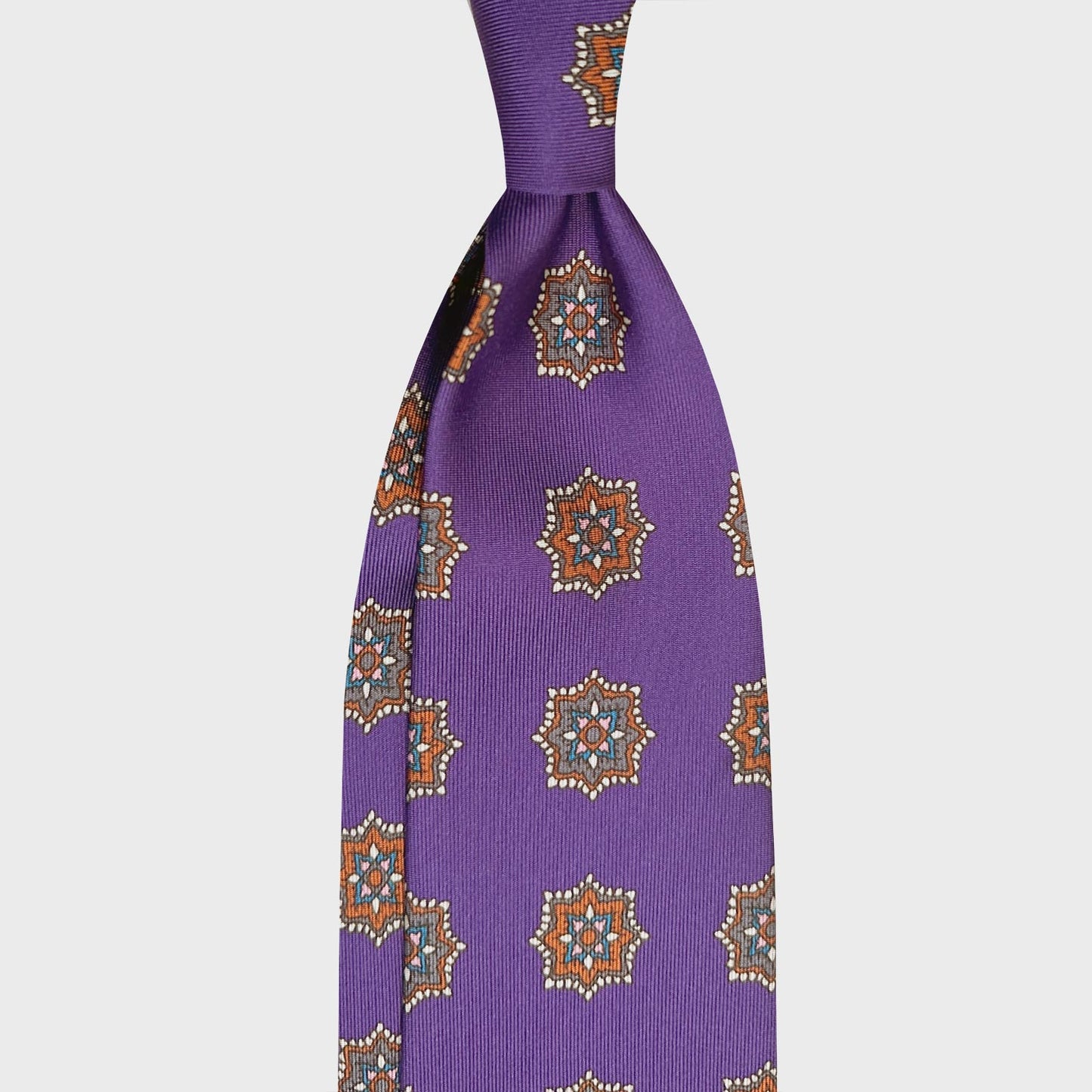 Violet Silk Tie Elegant Medallion Pattern Shop Now Geneva. Elegant violet silk tie, handmade in Italy F.Marino Napoli tie for Wools Boutique Uomo, violet background with rust brown and grey medallions pattern