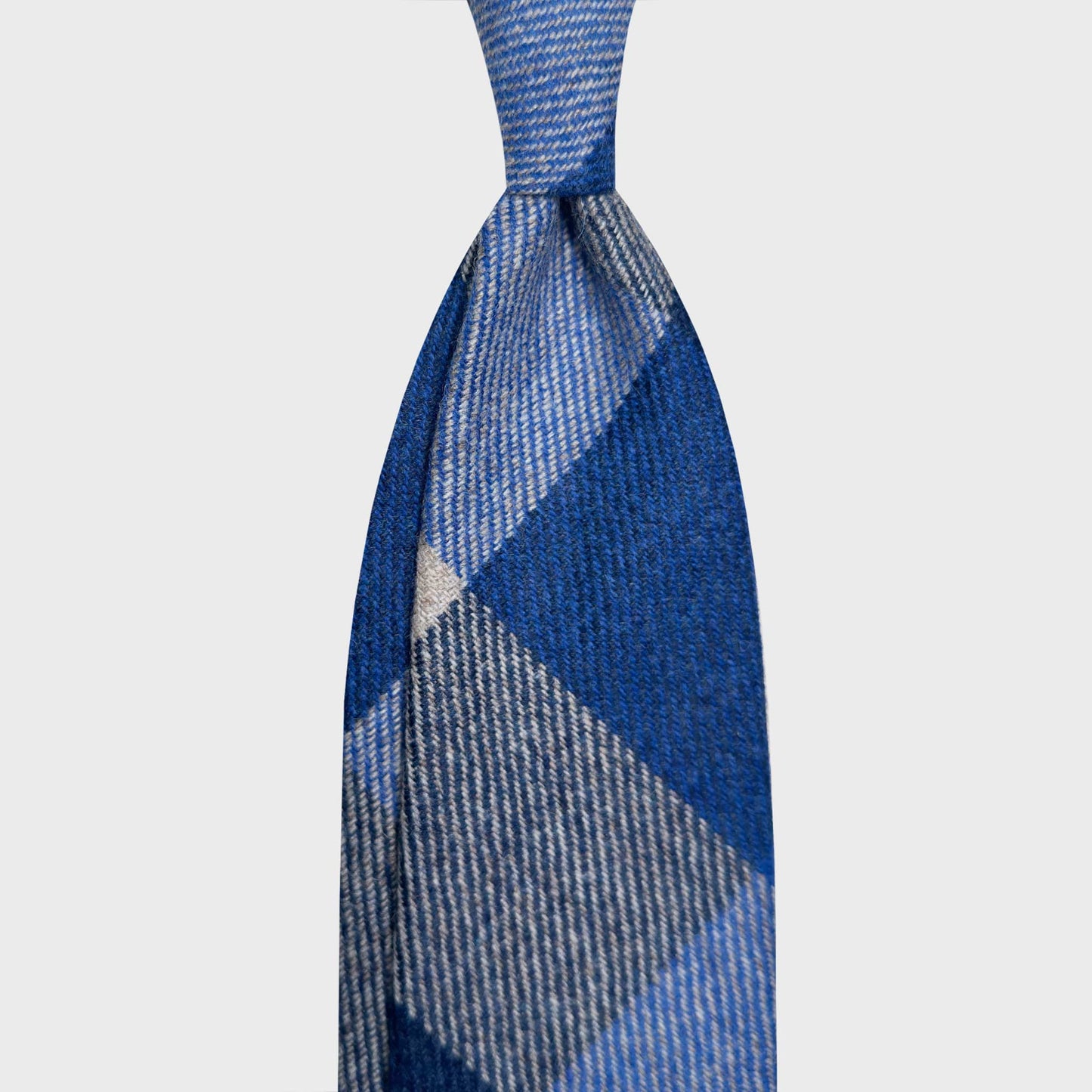 Cobalt Blue Bold Checked Wool Tie Hand Made in Italy. Exclusive wool ties available at men's ties store Geneva Wools Boutique Uomo, cobalt blue tie with bold checked pattern, handmade wool neckties made in Italy