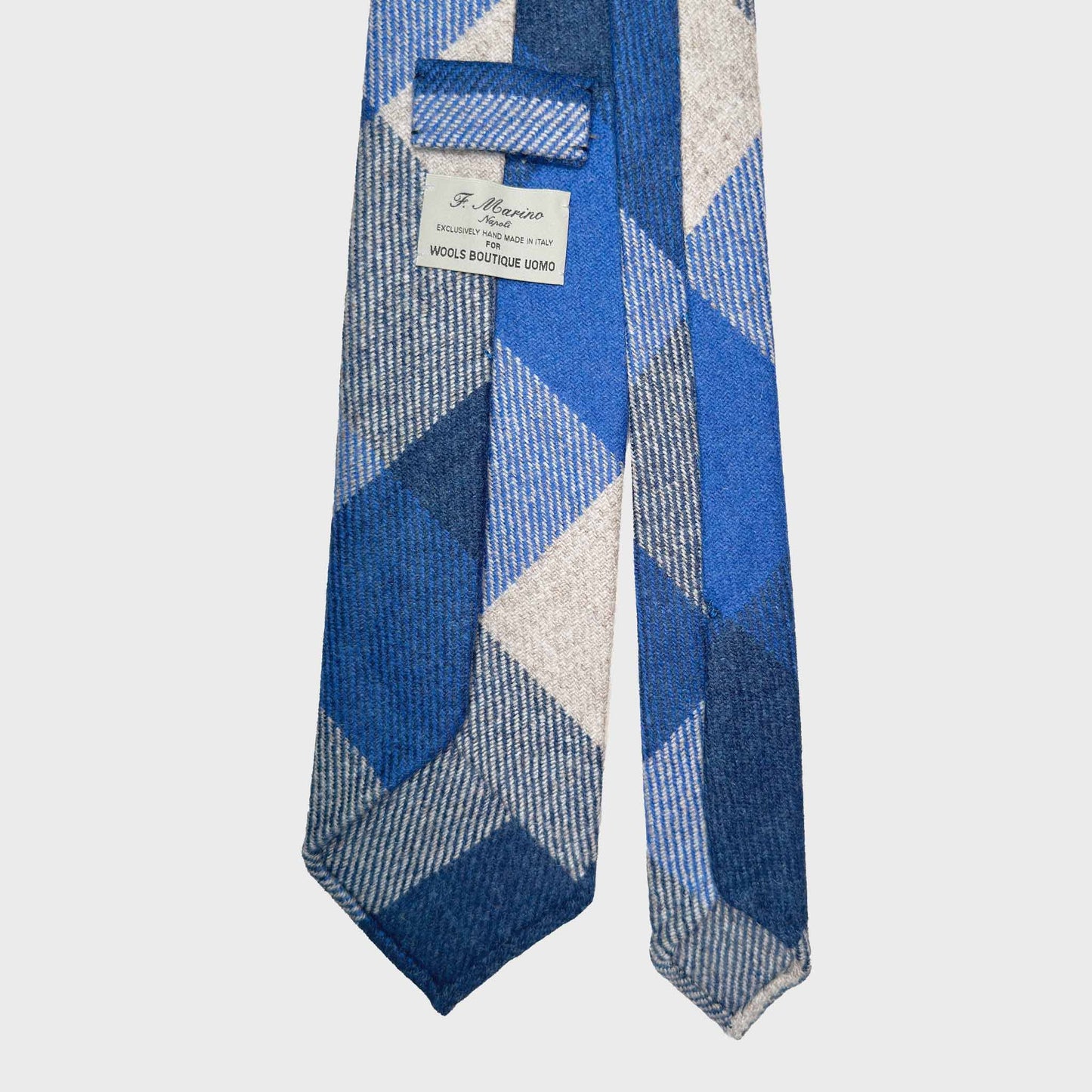 Exclusive wool ties available at men's ties store Geneva Wools Boutique Uomo, cobalt blue tie with bold checked pattern, handmade wool neckties made in Italy