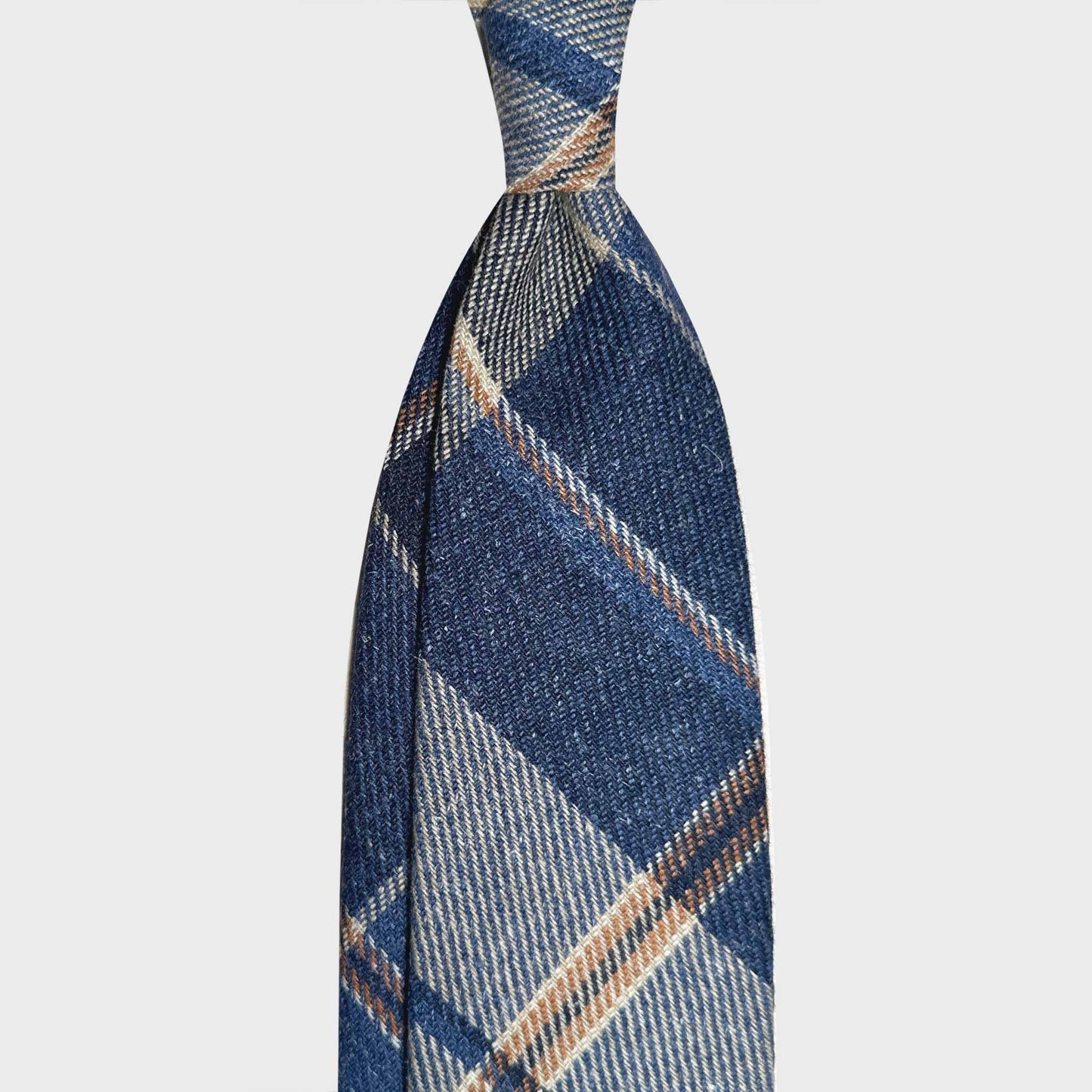 Denim Blue Windowpane Wool Tie Hand Made in Italy Exclusive wool ties available at men's ties store Geneva Wools Boutique Uomo, denim blue background, ocra and white windowpane pattern