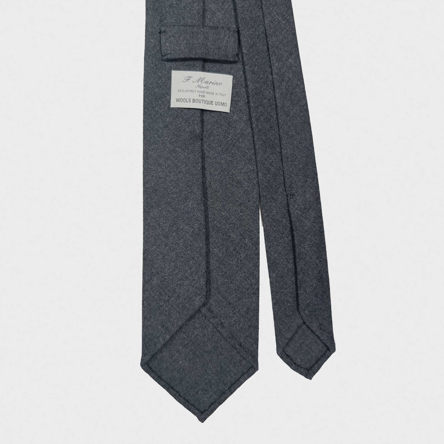 Timeless gray wool tie with classic graphite plain wool tie color, handmade in Italy ties available at men's neckties store Geneva Switzerland. F.Marino Napoli handmade ties for Wools Boutique Uomo