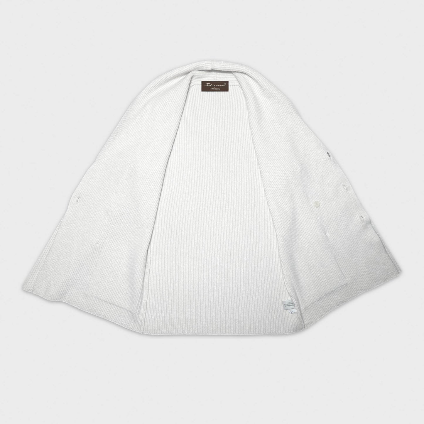 Cardigan blanc croisé à col châle en cachemire. Fabriqué à Genève en Italie par Doriani avec du cachemire de la plus haute qualité, ce cardigan en cachemire à col châle est idéal avec une chemise et une cravate ou un col ras du cou classique.