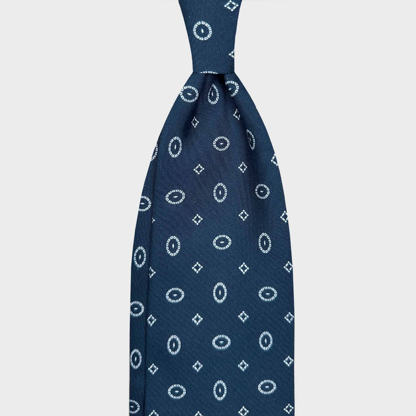Buy Men's Blue Silk Tie Classic Oval Fantasy Pattern. Tailoring indigo blue silk tie, white oval fantasy pattern, sartorial ties f marino napoli for Wools Boutique Uomo Geneva