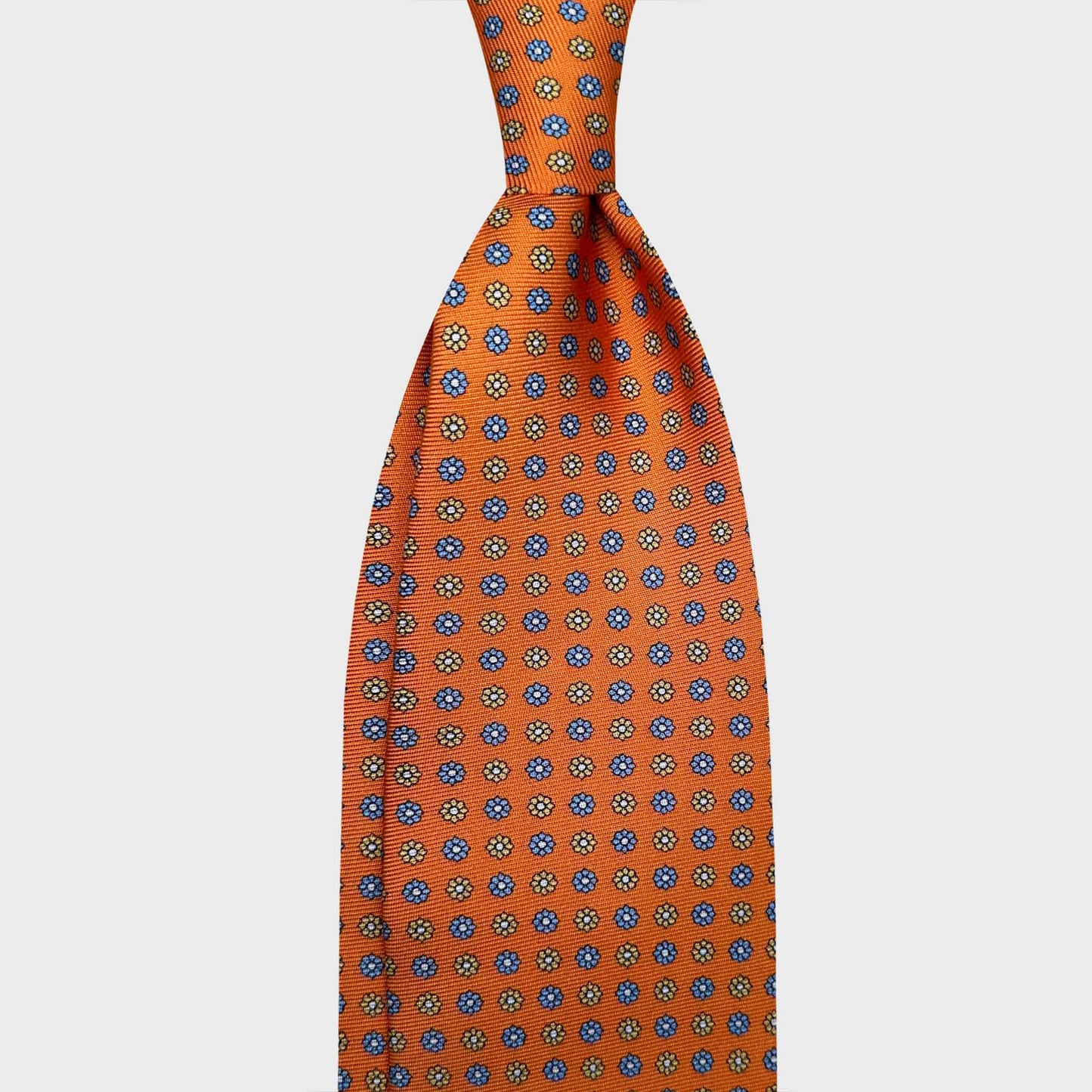 Orange Silk Tie 7 Folds Classic Micro Daisy. Brillant orange silk tie with light blue and soft beige micro daisy, madder seven folds silk ties F.Marino Napoli for Wools Boutique Uomo Genève