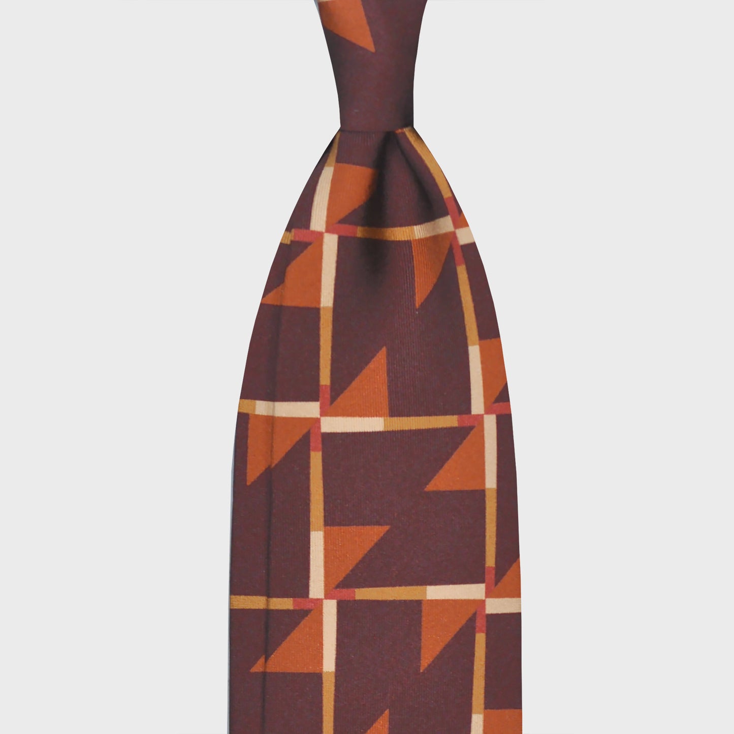 Coffee Brown Art Decò Pattern Silk Neckties. Refined deco tie made with finest Italian silk soft to the touch, coffee brown background with orange and ocra Art Decò pattern, unlined tie 3 folds, this Art Deco ties is a exclusive pattern made by Wools Boutique Uomo