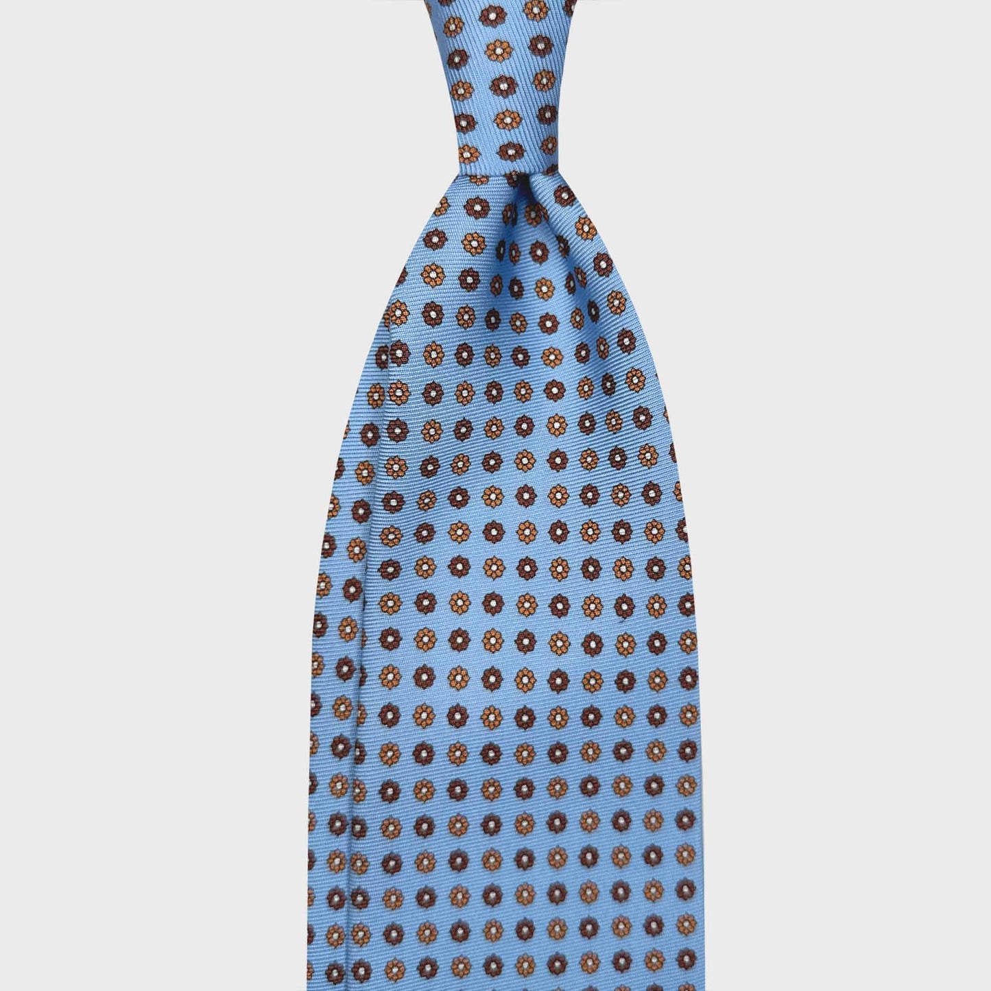 Light Blue Tie For Men Classic Daisy Pattern. Hand made light blue silk tie, coffee and rust brown daisy pattern, made in Italy sartorial ties f marino napoli for Wools Boutique Uomo Genève