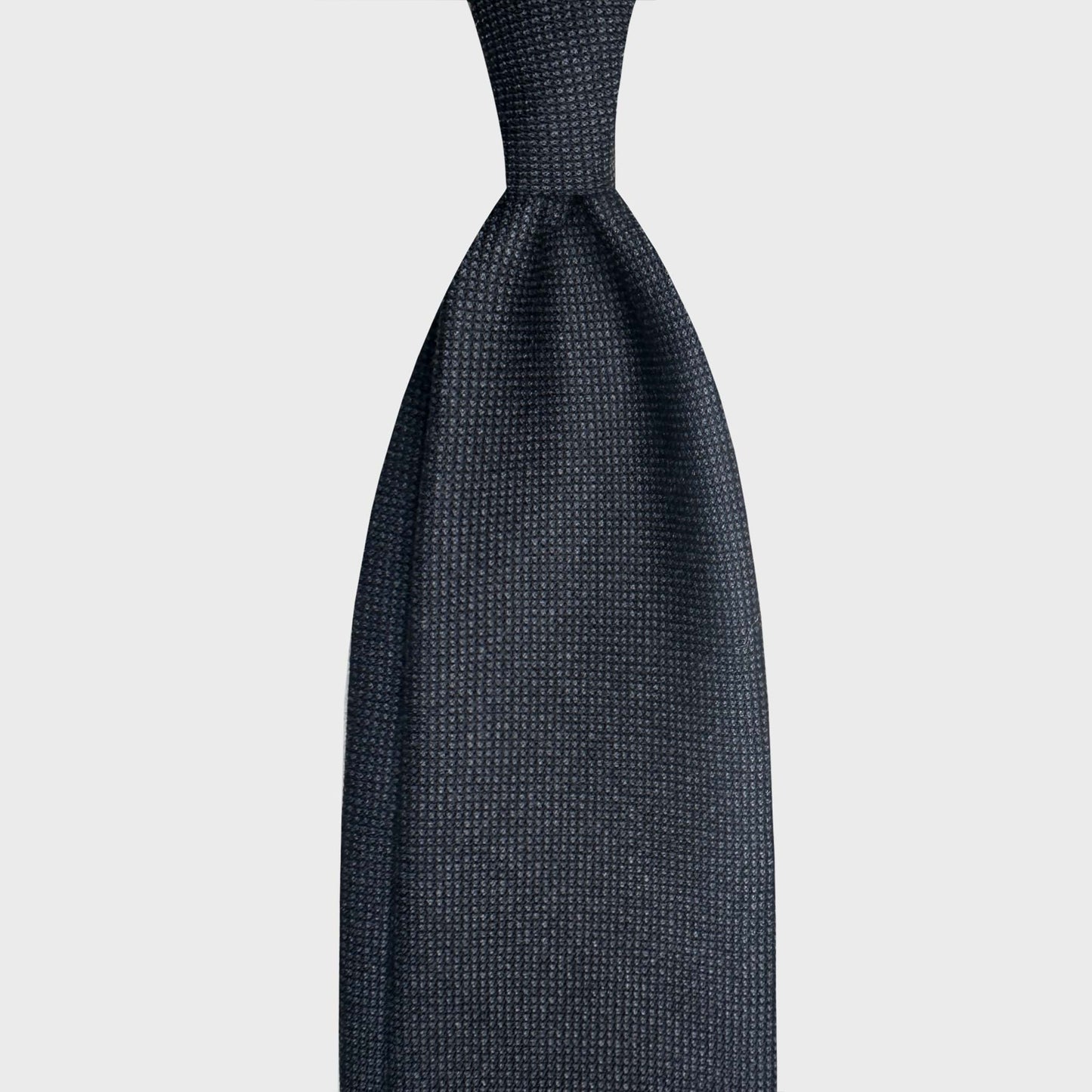 Birdseye Wool Tie Exclusive Elegant Weave Softness. Refined woven fabric for this wool ties available at men's ties store Geneva Wools Boutique Uomo, elegant and soft touch texture, anthracite grey and blue color