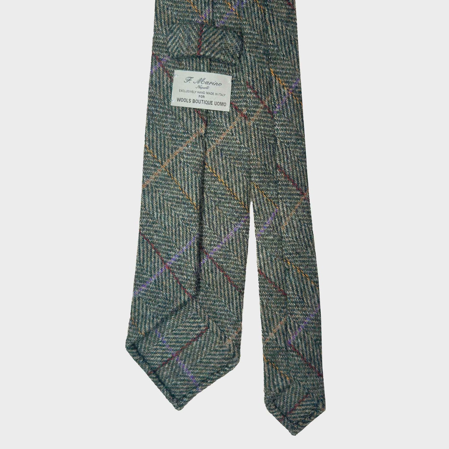 Timeless herringbone wool tie made with soft tweed wool fabric, olive green color, discover at Wools Boutique Uomo men's ties store in Geneva