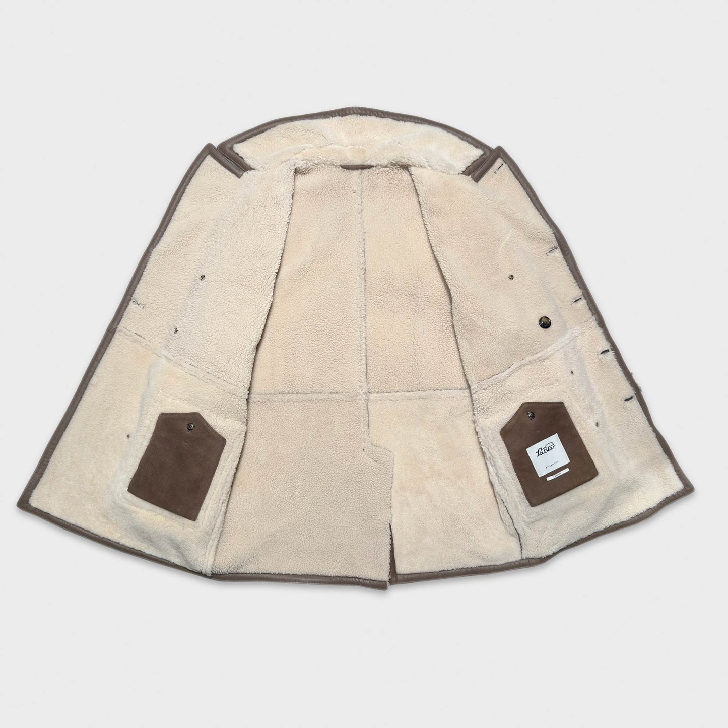 Add to your winter wardrobe our luxury walnut brown shearling peacoat, crafted in Italy by Valstar with the finest shearling lamb leather, this refined and stylish coat combines warmth and fashion timeless. The classic walnut brown color add a touch of sophistication ideal to any outfit, the shearling leather ensures ultimate comfort and warm for you winter outfit.