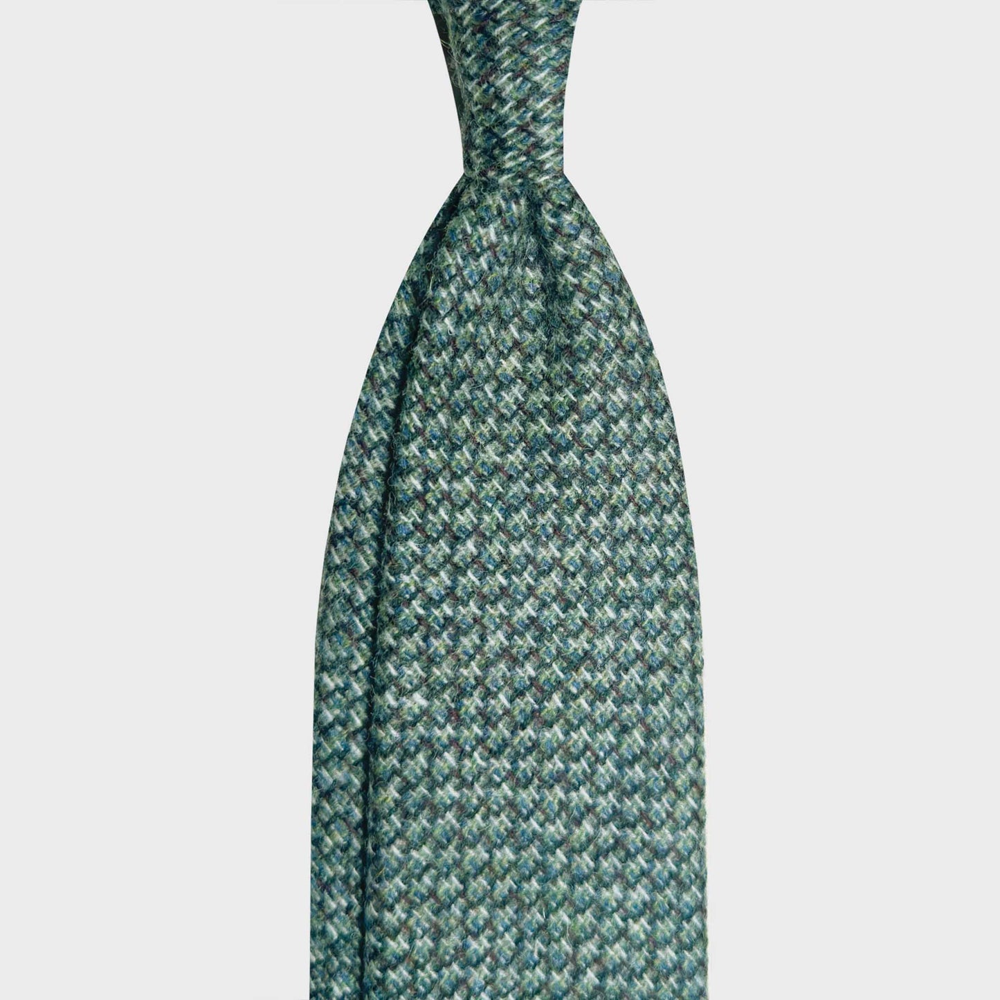 Green Wool Tie Mélange Basket Weave Unlined Hand Made in Italy Refined wool green tie made with carded wool woven basket weave fabric, soft to the touch, discover at Wools Boutique Uomo men's ties store in Geneva