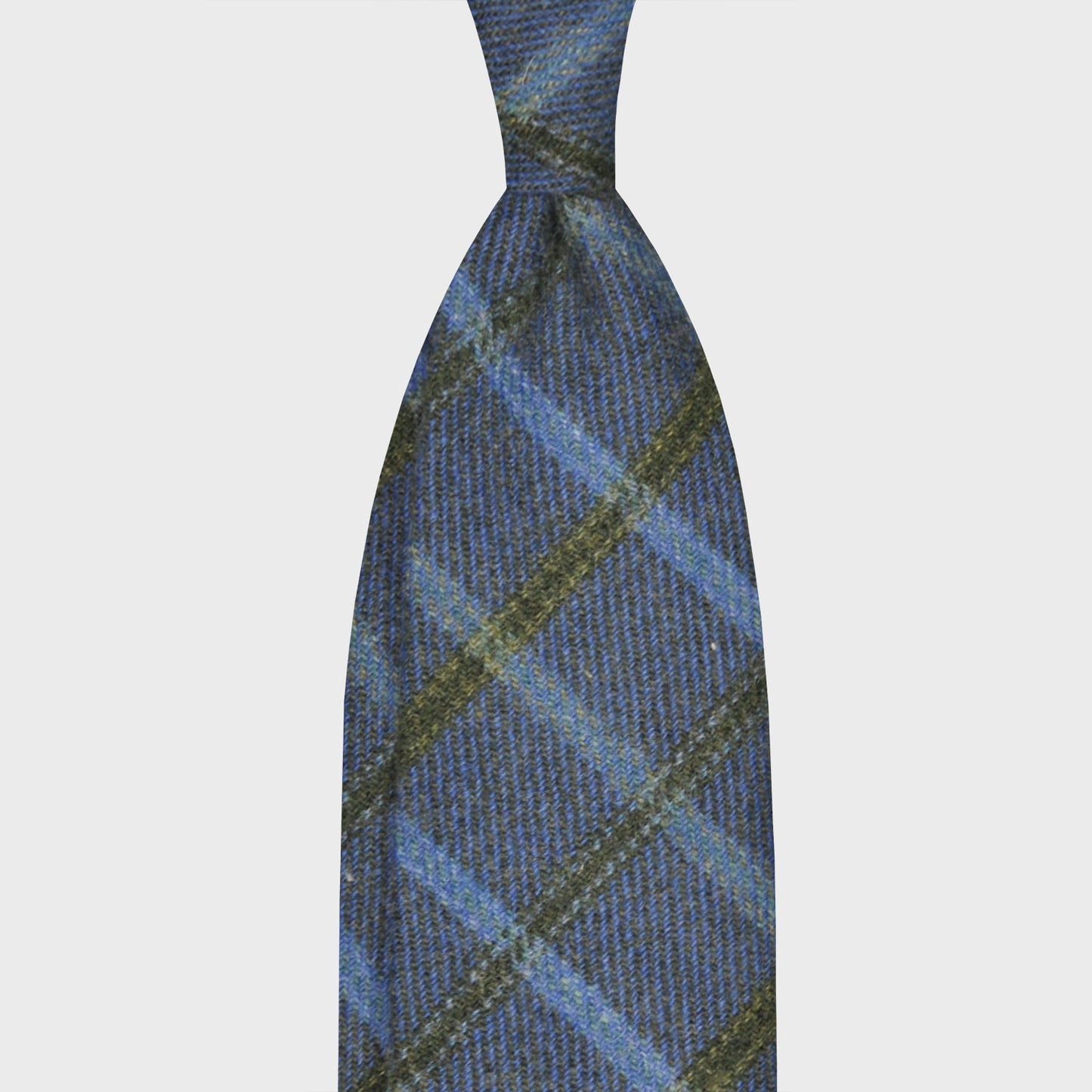 Windowpane Wool Tweed Tie Denim Blue. Discover the wool tweed tie collection at Wools Boutique Uomo Geneva, lightweight tweed with a soft texture, denim blue with a green and sky windowpane pattern