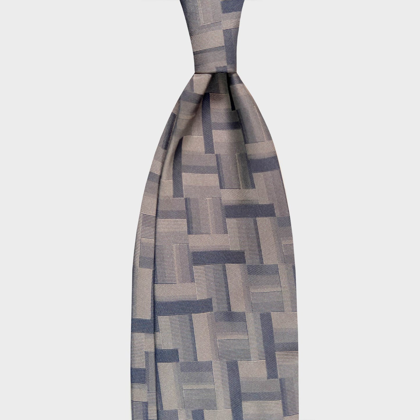 Champagne Beige Silk Tie Geometry Patchwork Pattern Navy. Beige jacquard silk tie with a refined jacquard design with architectural character, ideal for contemporary business and elegant formal menswear.