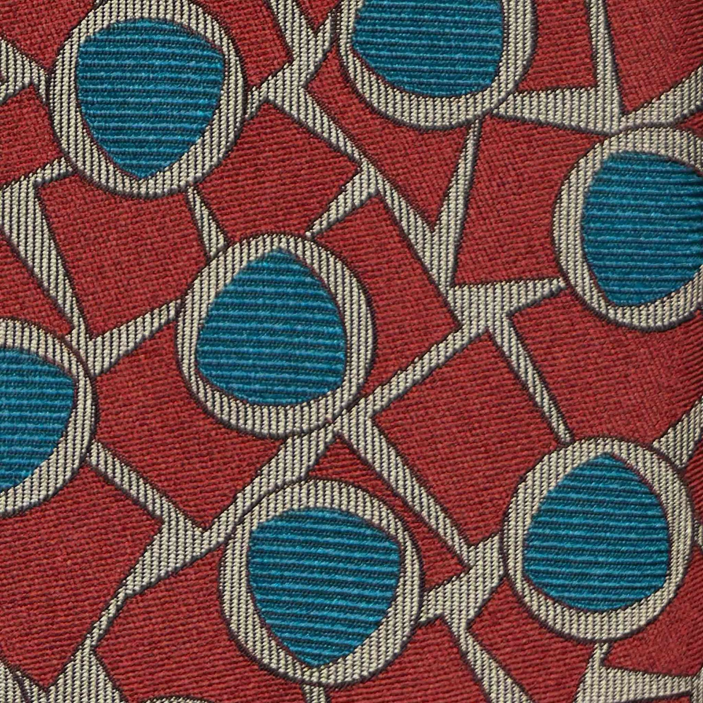 Art Déco mosaic pattern silk tie in ruby red and teal blue detail