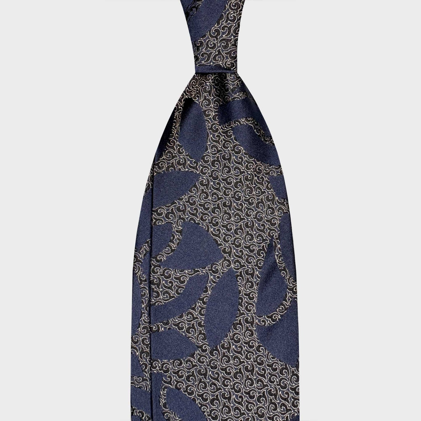 Navy Blue Art Deco Scrollwork Silk Tie Italian Elegance. Discover this blue Art Deco scrollwork silk tie at Wools Boutique Uomo Geneva. Handmade in Italy for refined business attire and timeless sartorial elegance.