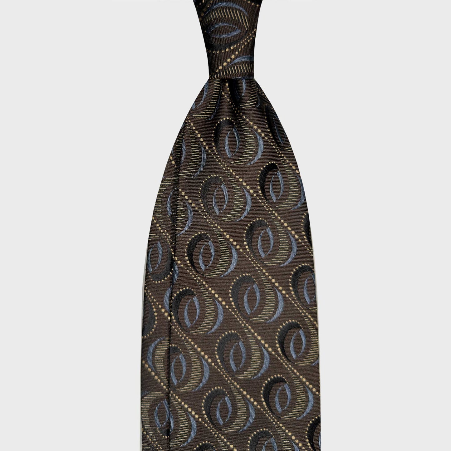 Coffee Brown Modernist Silk Tie Geneva Switzerland Menswear. Coffee brown silk tie with a modernist diagonal oval pattern and light blue. Ties handmade in Italy for refined business style at Wools Boutique Uomo Geneva
