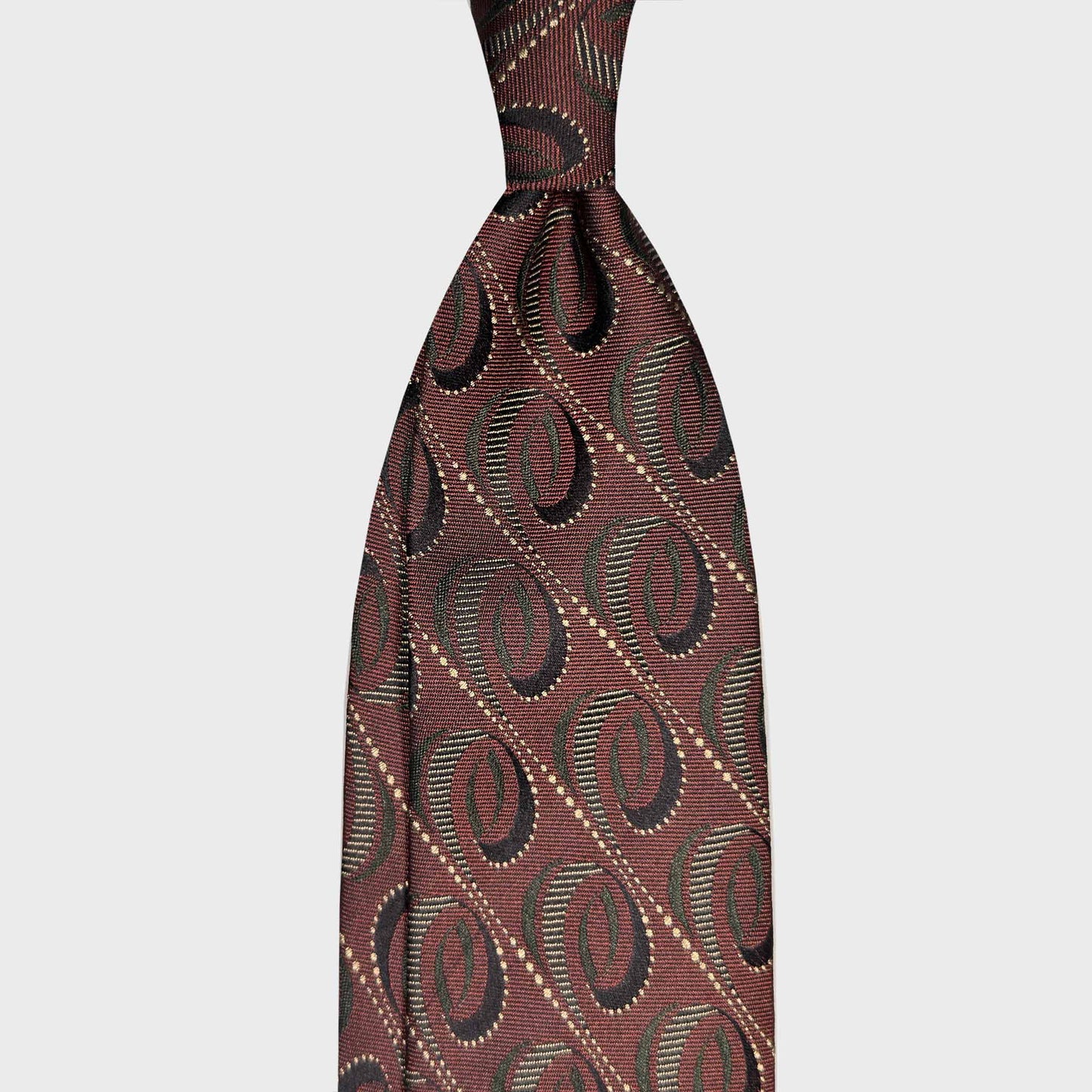 Burgundy Red Modernist Silk Tie Geneva Luxury Menswear. Burgundy red silk tie with a modernist diagonal oval pattern and olive green. Ties handmade in Italy for refined business style at Wools Boutique Uomo Geneva.