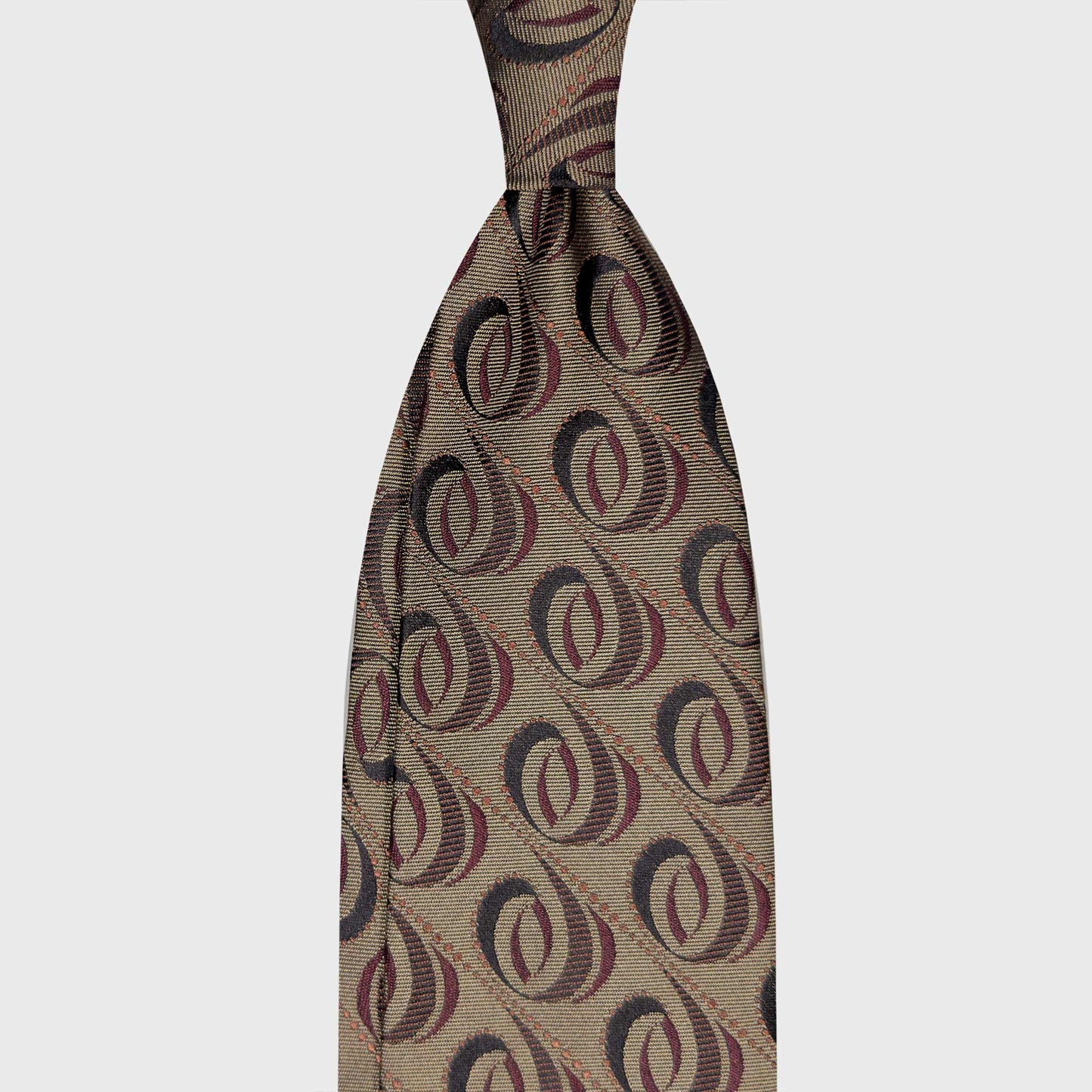 Taupe Beige Modernist Silk Tie Geneva Wools Boutique Uomo Classic Menswear. Taupe beige silk tie with a modernist diagonal oval pattern in burgundy and brown tones. Handmade in Italy for refined menswear.