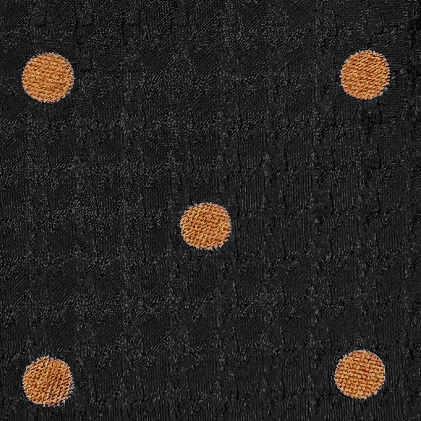 Detail of copper orange bold pois on black textured silk tie