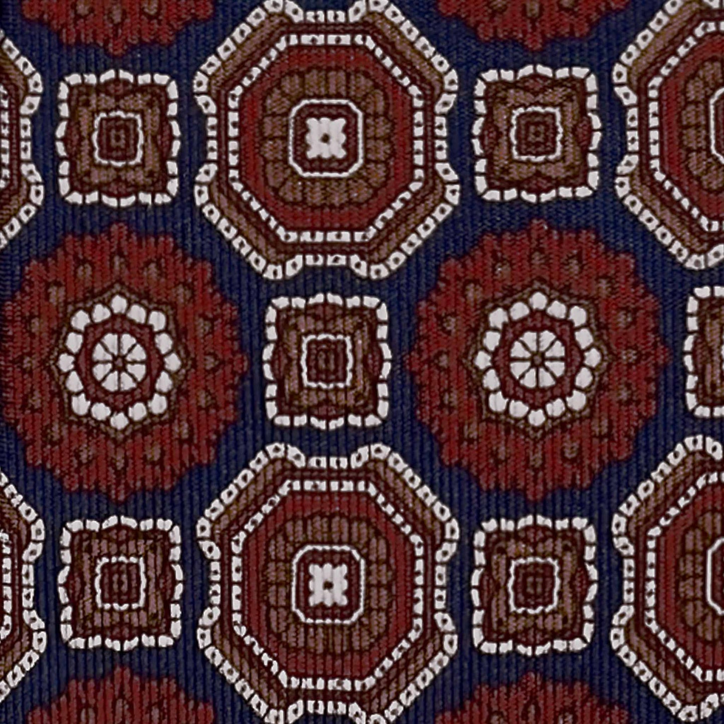 Detail of navy blue silk tie with burgundy and ivory maiolica motif