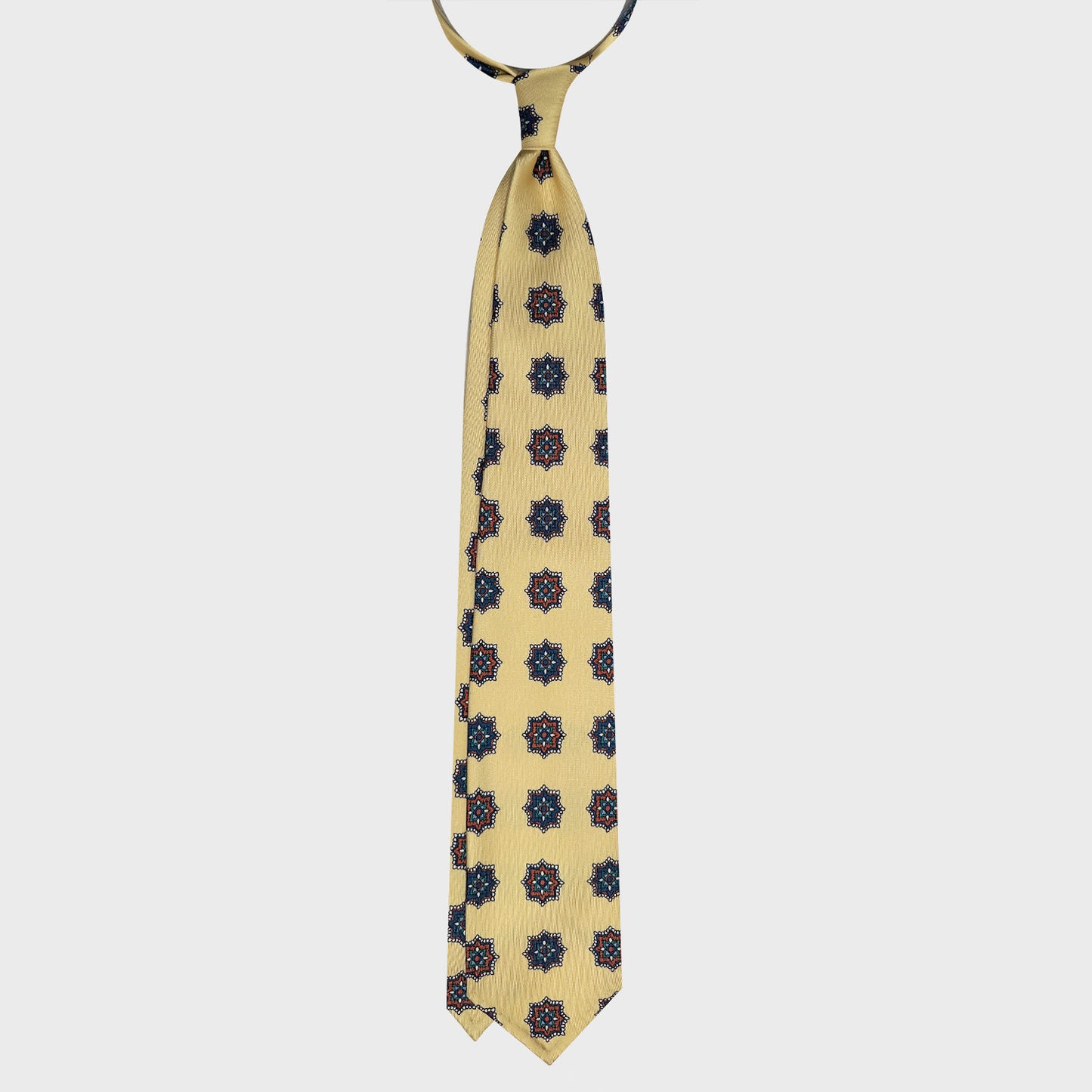 Refind honey yellow silk tie, exclusive handmade in Italy Wools Boutique Uomo Geneva, honey yellow background with rust brown and navy blue medallions pattern