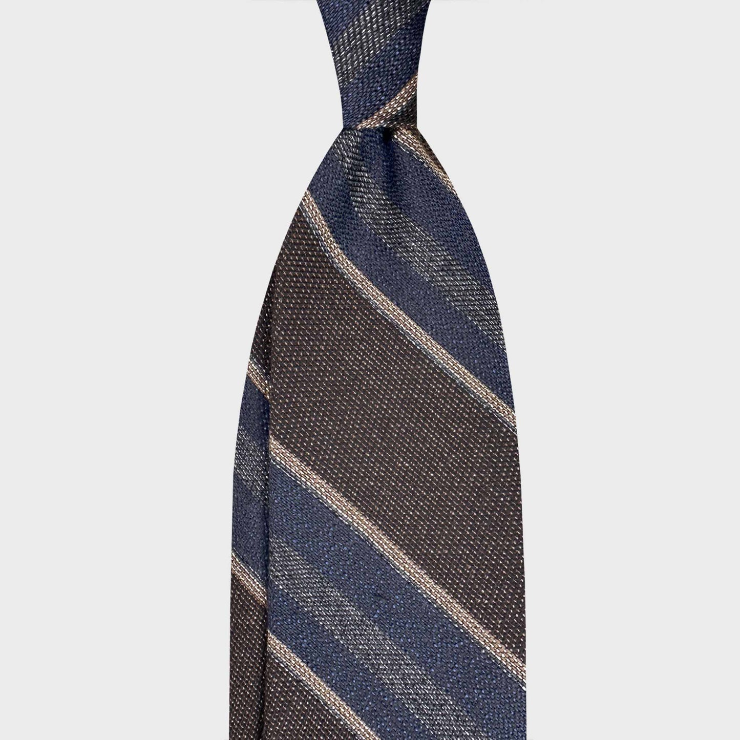 Handmade F.Marino panama silk regimental tie in mud brown with denim blue and ivory stripes. Crafted in Naples for Wools Boutique Uomo Geneva.