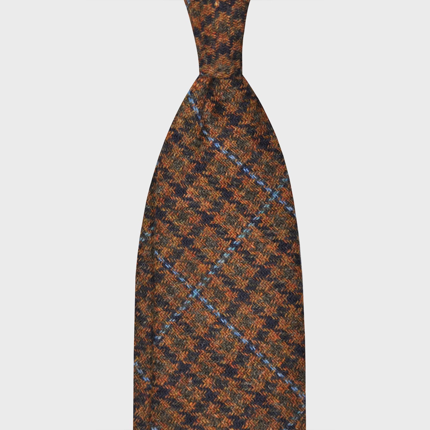 Brown Tweed Tie Unlined Pied de Poule Pattern. Elegant tweed tie, wool texture to the touch bristly feeling, unlined tie handmade in Italy by F.Marino Napoli exclusive for Wools Boutique Uomo, pied de poule pattern brown and green, light blue windowpane.