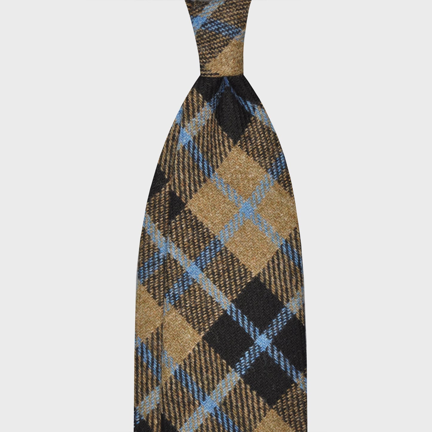 Camel Plaid Checks Wool Tweed Unlined Handmade Tie. Unlined wool tie, hand rolled edge, 100% wool tweed, light weight, soft texture to the touch, bristly feeling, F Marino ties for Wools Boutique Uomo, camel and dark blue checks pattern