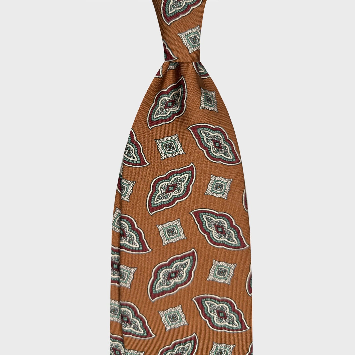 Caramel Brown Silk Tie Bold Diamonds Pattern. Caramel brown silk tie featuring a bold diamonds pattern. A refined Italian tie for classic tailoring men's clothing, available at Wools Boutique Uomo Geneva.