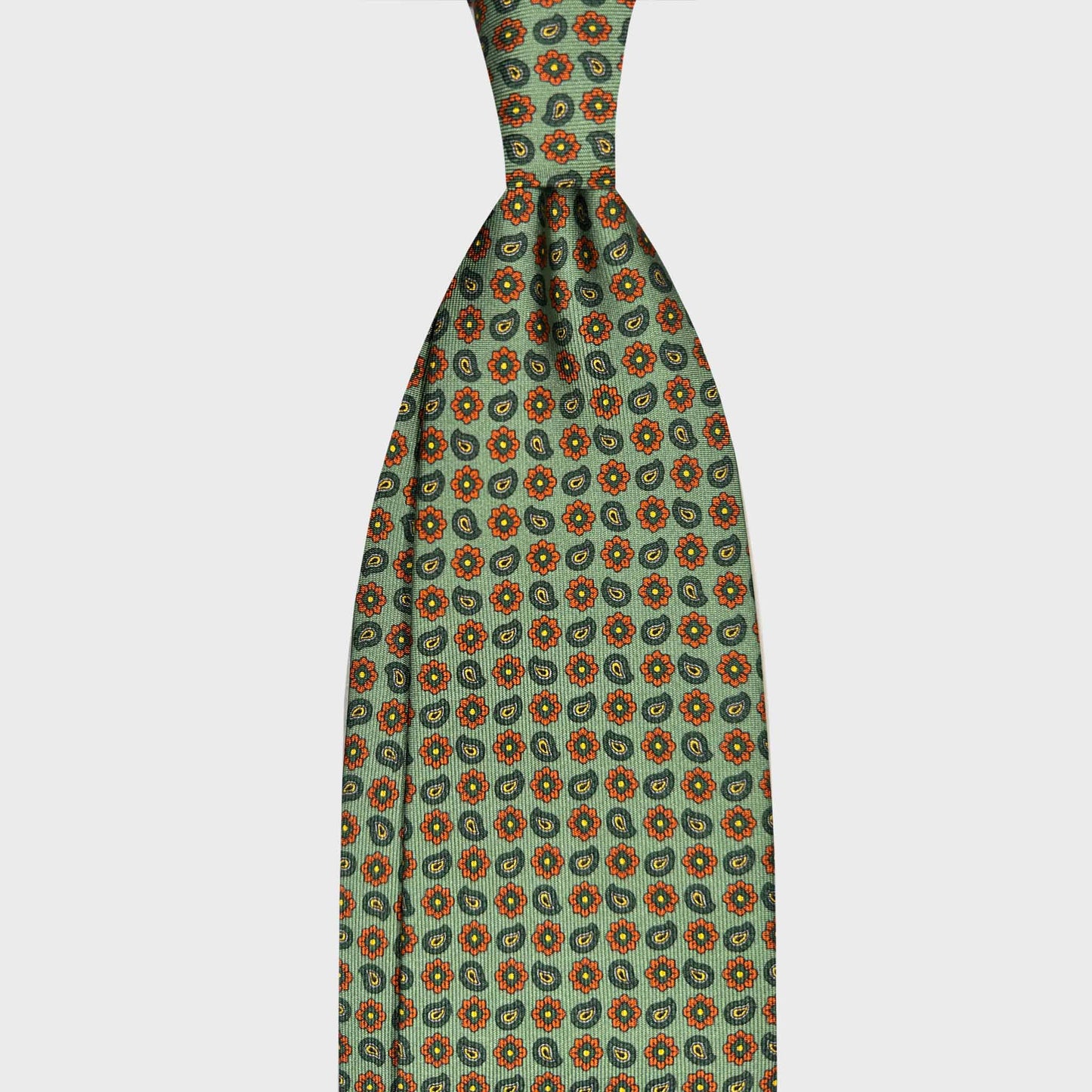 Men's Classic Loden Green Silk Tie Micro Daisy Paisley Pattern. Green silk tie with micro daisy and paisley pattern. Handmade in Italy and selected by Wools Boutique Uomo Geneva for elegant business and sartorial clothing.