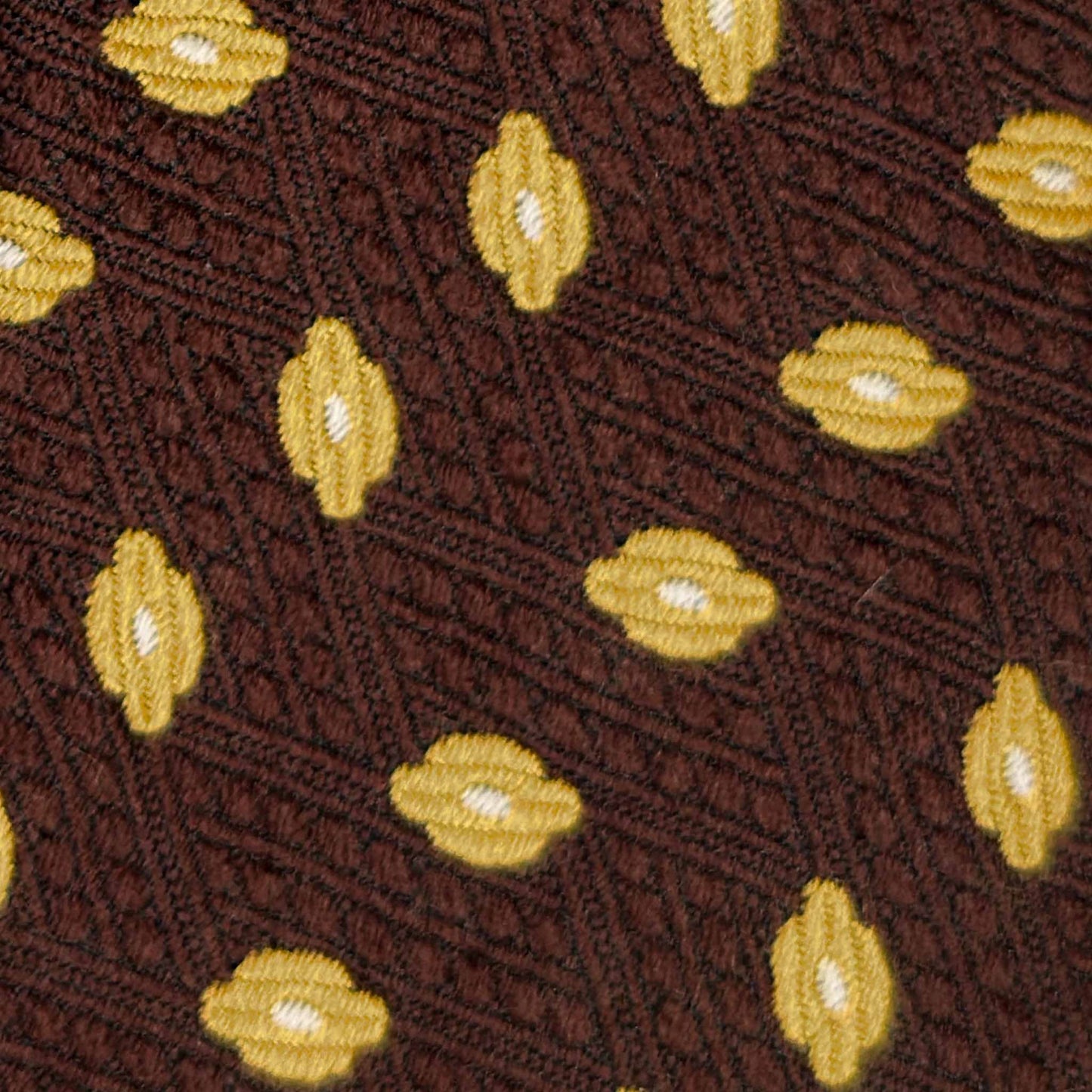 Detail of yellow diamond pattern on coffee brown wool tie