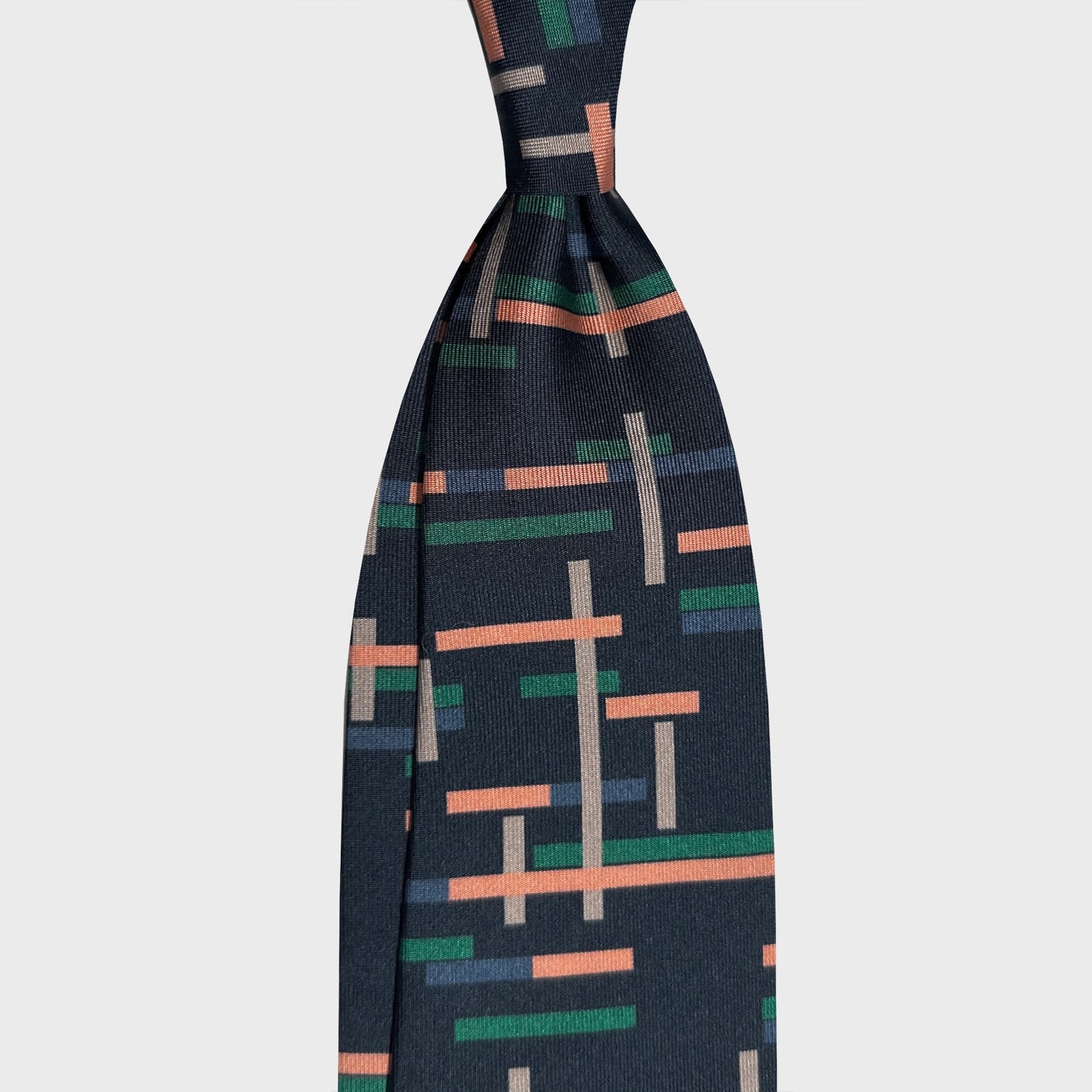 Navy Blue Tie Art Decò Pattern. Blue silk tie made with a exclusive pattern made by Wools Boutique Uomo Geneva, navy blue color background, unlined tie made in Italy, discover in Grand-Rue 13 Ville de Geneve