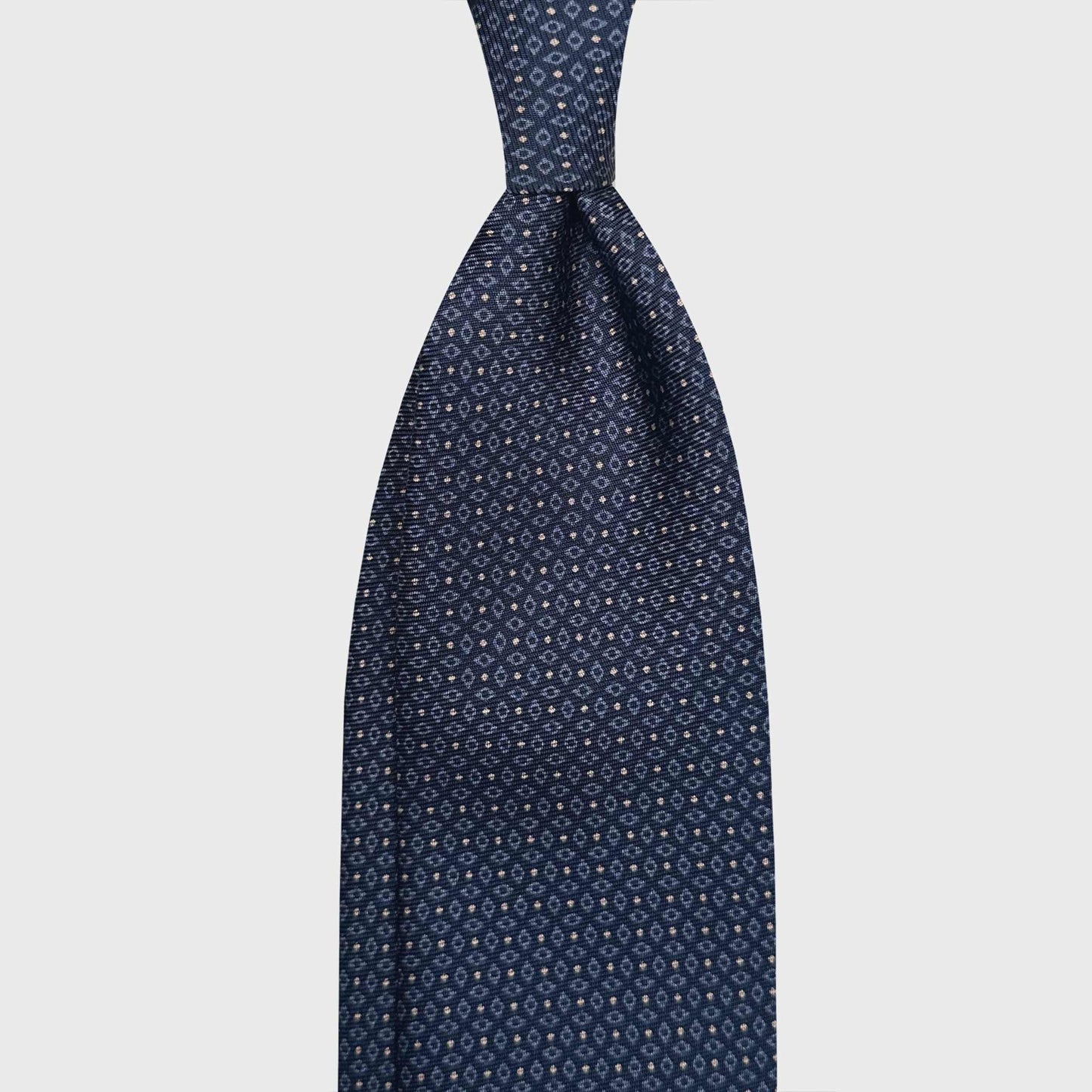 Elegant Blue Madder Silk Tie 7 Fold Light Blue Micro Rhombuses. Classic silk tie with blue background and micro beige pois, light blue micro rhombuses, seven folds silk ties F.Marino Napoli for Wools Boutique Uomo Genève