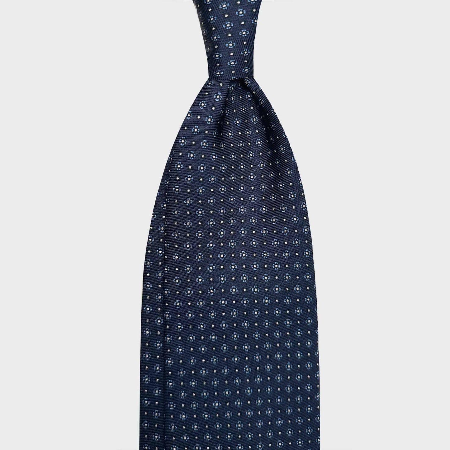 Handmade Silk Tie 7 Folds White Blue Micro Daisy. Blue silk tie, dark blue and white micro daisy, light blue and white micro daisy, madder seven folds silk ties F.Marino Napoli for Wools Boutique Uomo Genève