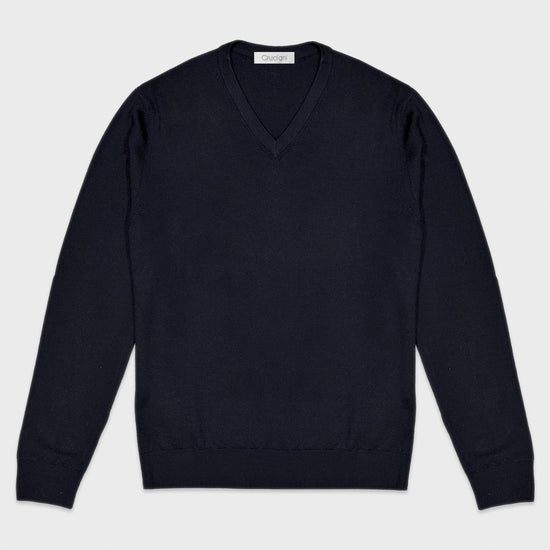Navy Blue V Neck Merino Wool Sweater Cruciani. Classic sweater merino wool v neck model regular fit, finished with the 2cm small edge ribbed detail. Light and smooth to the touch, ideal for a classic basic outfit with a shirt and tie. 