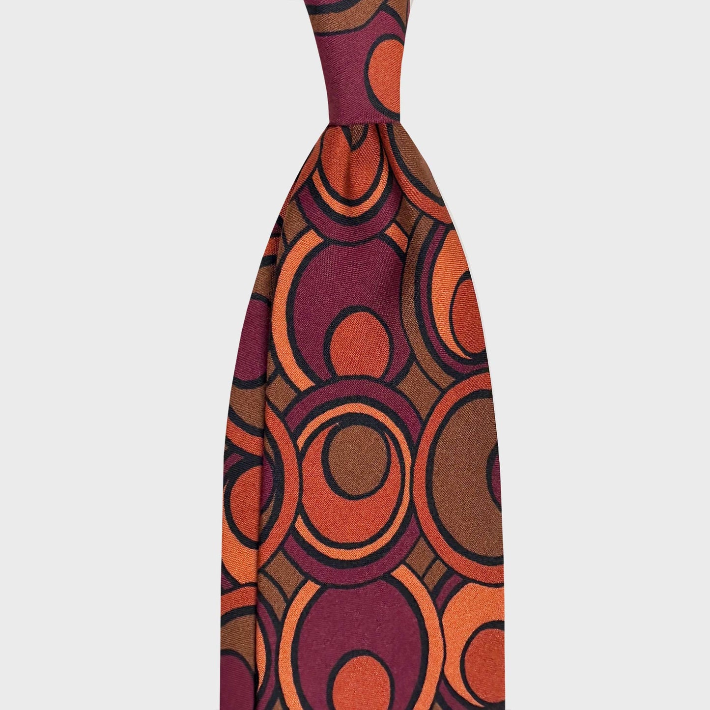 Silk Tie Art Deco 60s Circular Design Magenta Burnt Orange. Statement silk tie inspired by 60s Art Deco design, featuring circular motifs in magenta and burnt orange. Handmade in Italy for refined contemporary style.