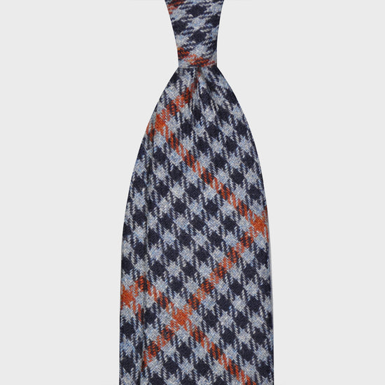 Denim Blue Tweed Necktie Classic Checked. Cool tweed tie, wool texture to the touch bristly feeling, unlined checked wool tie handmade in Italy by F.Marino Napoli exclusive for Wools Boutique Uomo, light blue denim background and navy blue checked, orange windowpane pattern