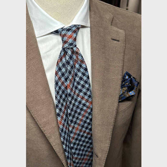 Cool tweed tie, wool texture to the touch bristly feeling, unlined checked wool tie handmade in Italy by F.Marino Napoli exclusive for Wools Boutique Uomo, light blue denim background and navy blue checked, orange windowpane pattern