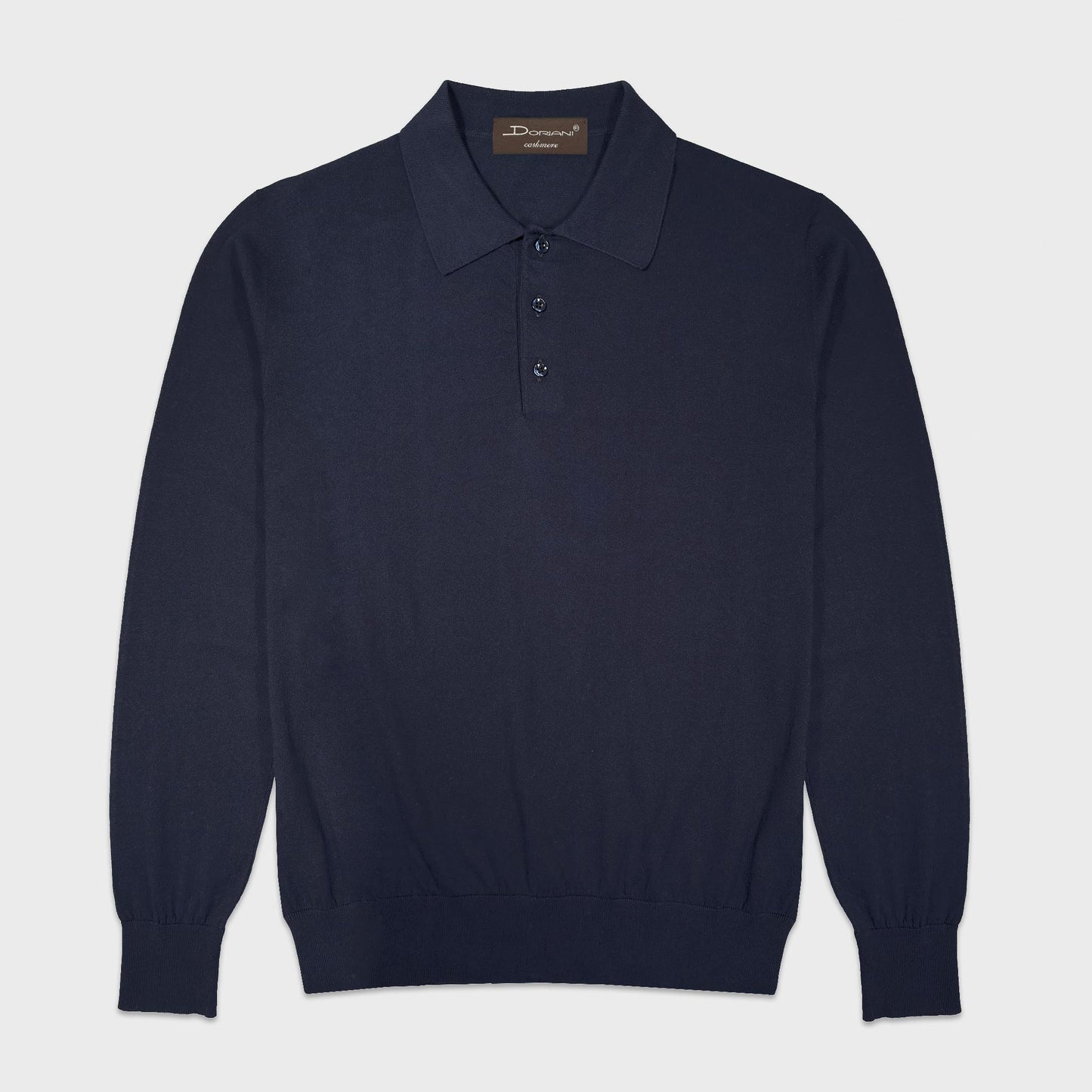 Doriani Navy Blue Cotton Long Sleeve Polo Made in Italy. Navy blue long sleeve polo by Doriani in lightweight 100% cotton. Soft, refined and versatile knitwear designed for relaxed tailoring and elegant everyday wear. Selected by Wools Boutique Uomo in Geneva for its balance of comfort, versatility and understated Italian refinement.