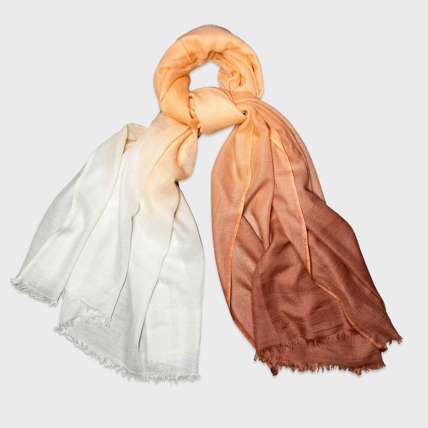 Faliero Sarti 100% cashmere scarf featuring an elegant caramel to beige gradient fading into ivory. Lightweight Italian cashmere scarf with refined unisex styling. Made in Italy.