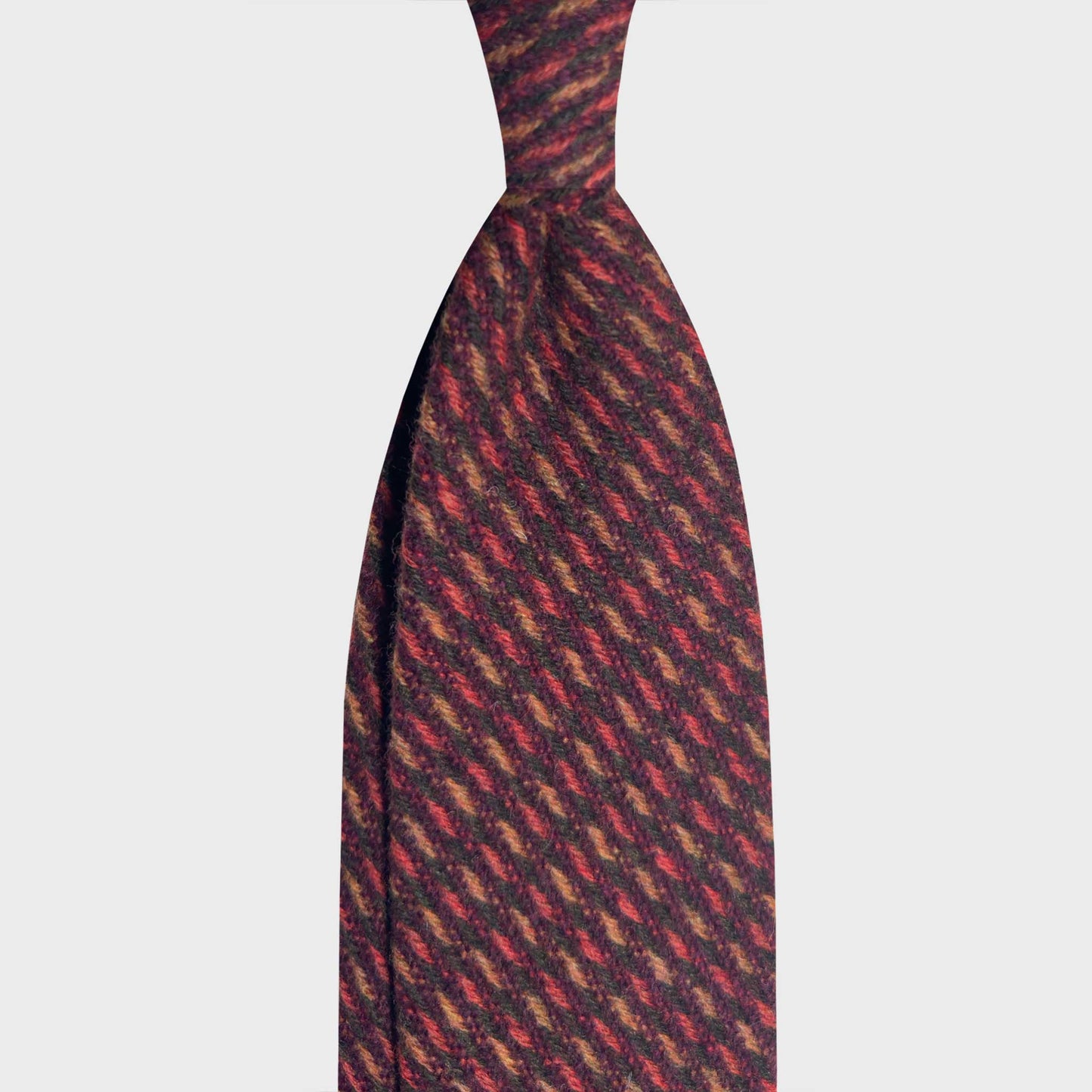 Exclusive Mélange Red Flannel Wool Tie Hand Made in Italy. For lovers of soft and consistent wool flannel ties available at men's ties store Geneva Wools Boutique Uomo, soft touch texture, mélange red and ocra yellow