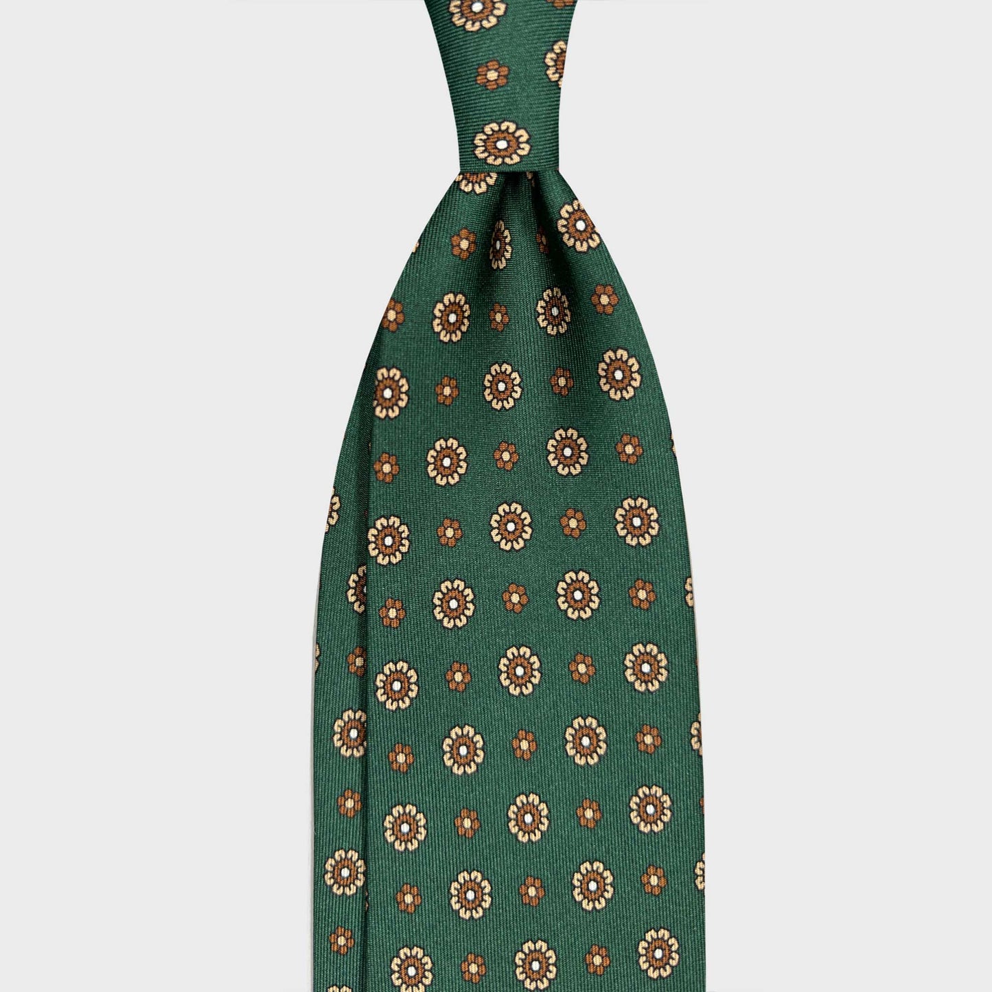 Forest Green Silk Tie Classic Daisy Pattern. Forest green silk tie with an elegant daisy pattern in cream, tobacco brown and light blue tones. A refined Italian tie available at Wools Boutique Uomo Geneva.