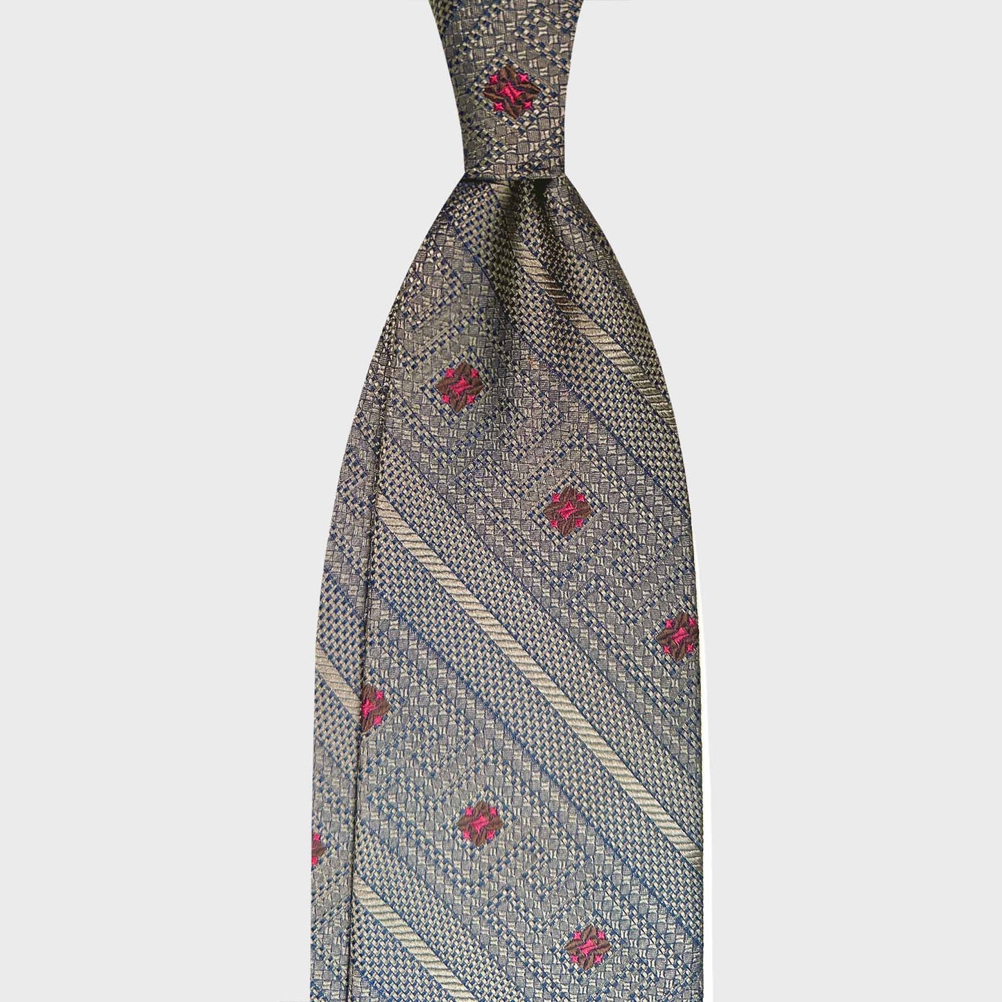 Antique Gold Regimental Silk Tie Embroidered Diamonds Ruby Motifs. Elegant silk tie in antique gold with ruby diamond motifs, handmade in Italy by F. Marino Napoli, available at Wools Boutique Uomo Geneva.