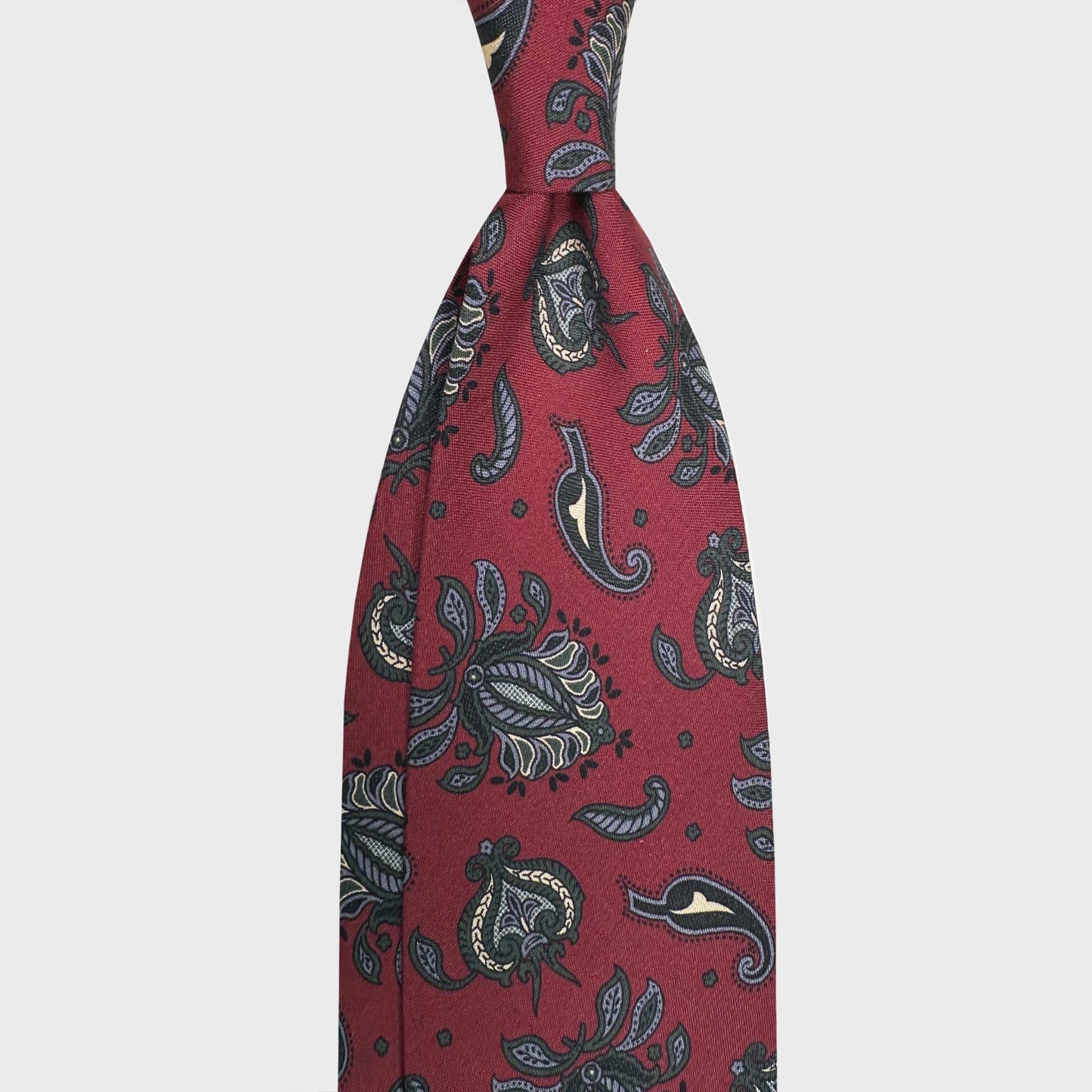 Brick Red Silk Tie Floral Ornamental Design Italian Heritage. Silk tie with a refined floral ornamental paisley motif on brick red background with green and ivory accents. Handmade in Italy, ideal for timeless outfit. F.Marino Napoli handmade ties available at Wools Boutique Uomo Geneva.