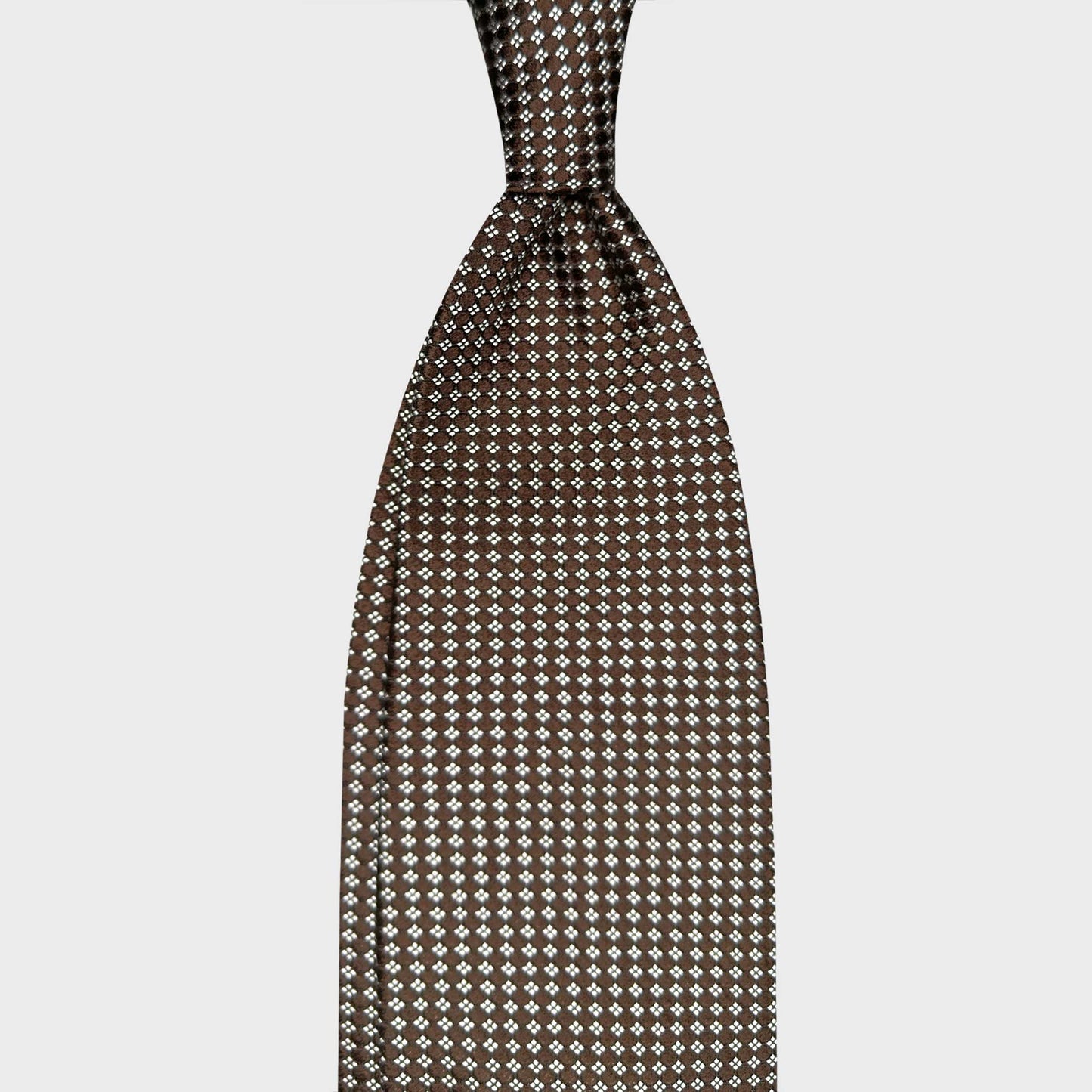 Made in Italy Silk Tie Classic Deep Brown Micro Diamonds Pattern. Deep brown silk tie with refined micro diamond pattern. Handmade in Italy and curated by Wools Boutique Uomo Geneva for elegant business and formal outfits.