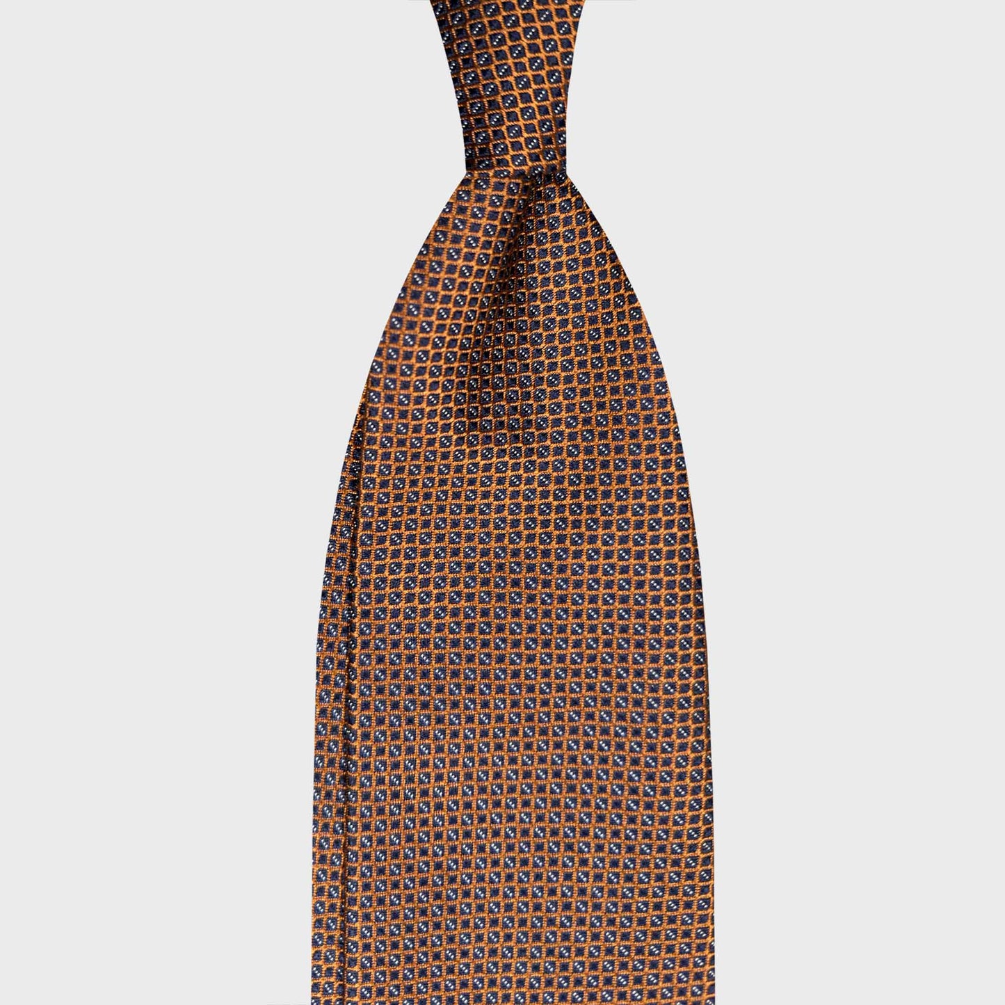 Copper Brown Silk Tie Micro Grid Pattern Made in Italy. Refined copper brown silk tie with micro grid pattern. Handmade Italian tie curated by Wools Boutique Uomo Geneva for elegant business style.