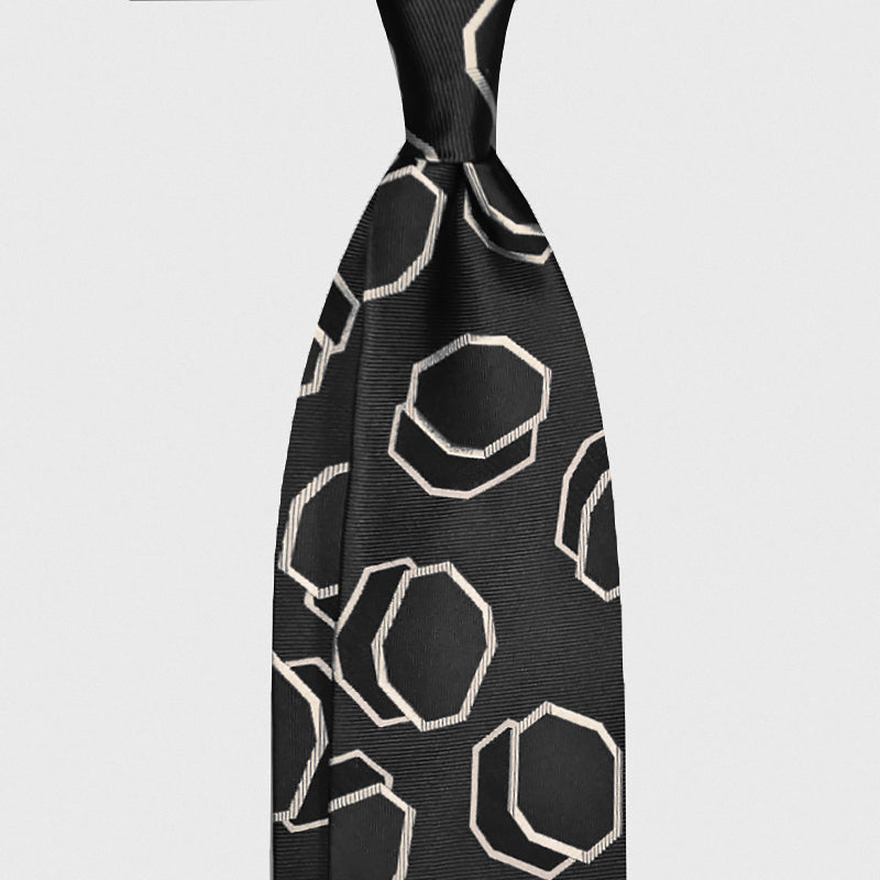 Black Silk Tie Art Deco Octagon Pattern Ivory. Black silk tie featuring an Art Deco octagon pattern in ivory tones. Ideal for elegant business attire and contemporary formal styling.