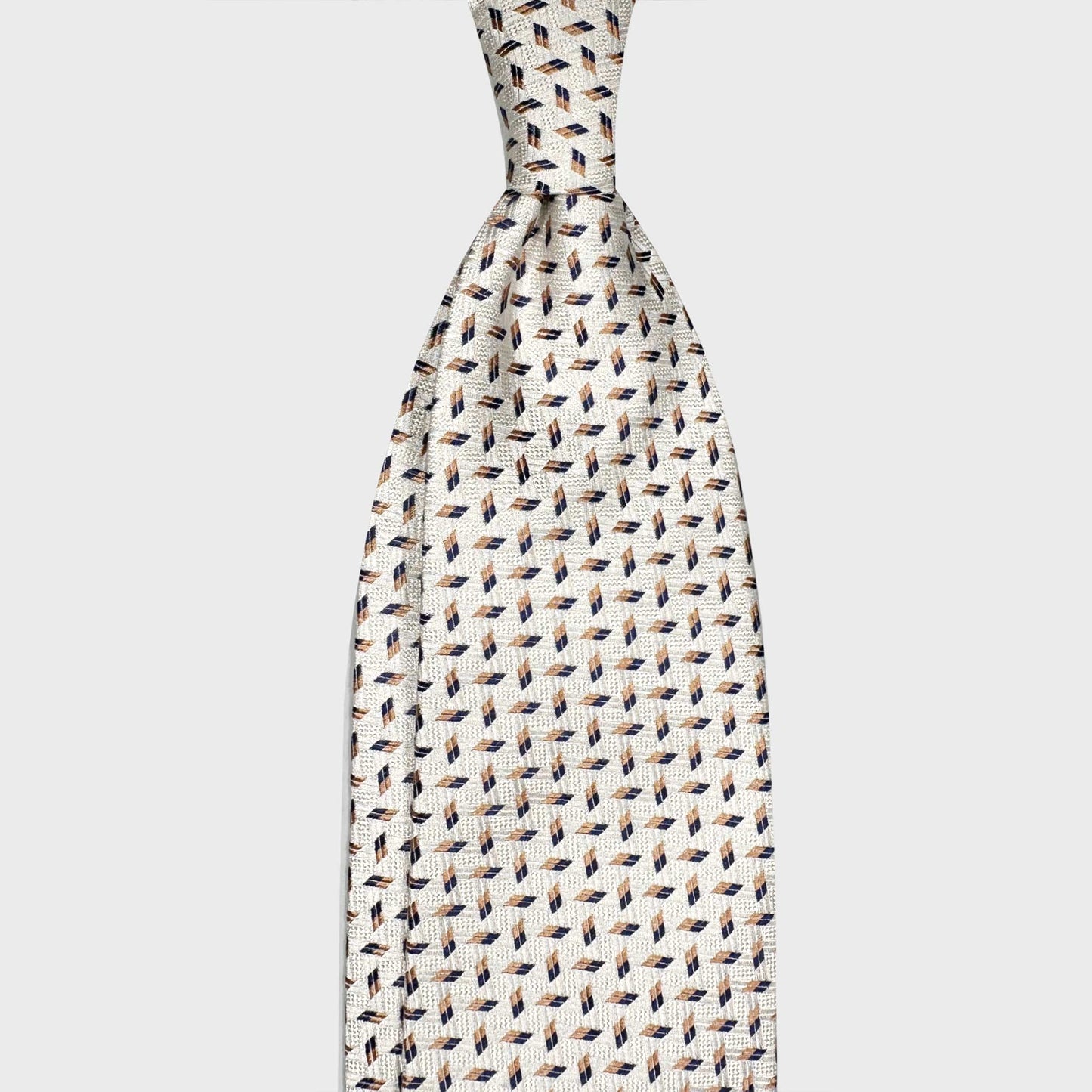 Men's Clothing Geneva Ivory White Silk Tie Micro Geometric Tile. Refined and versatile ivory white silk tie, micro geometric tile pattern beige and navy, available at Wools boutique Uomo Geneva, handmade in Italy.