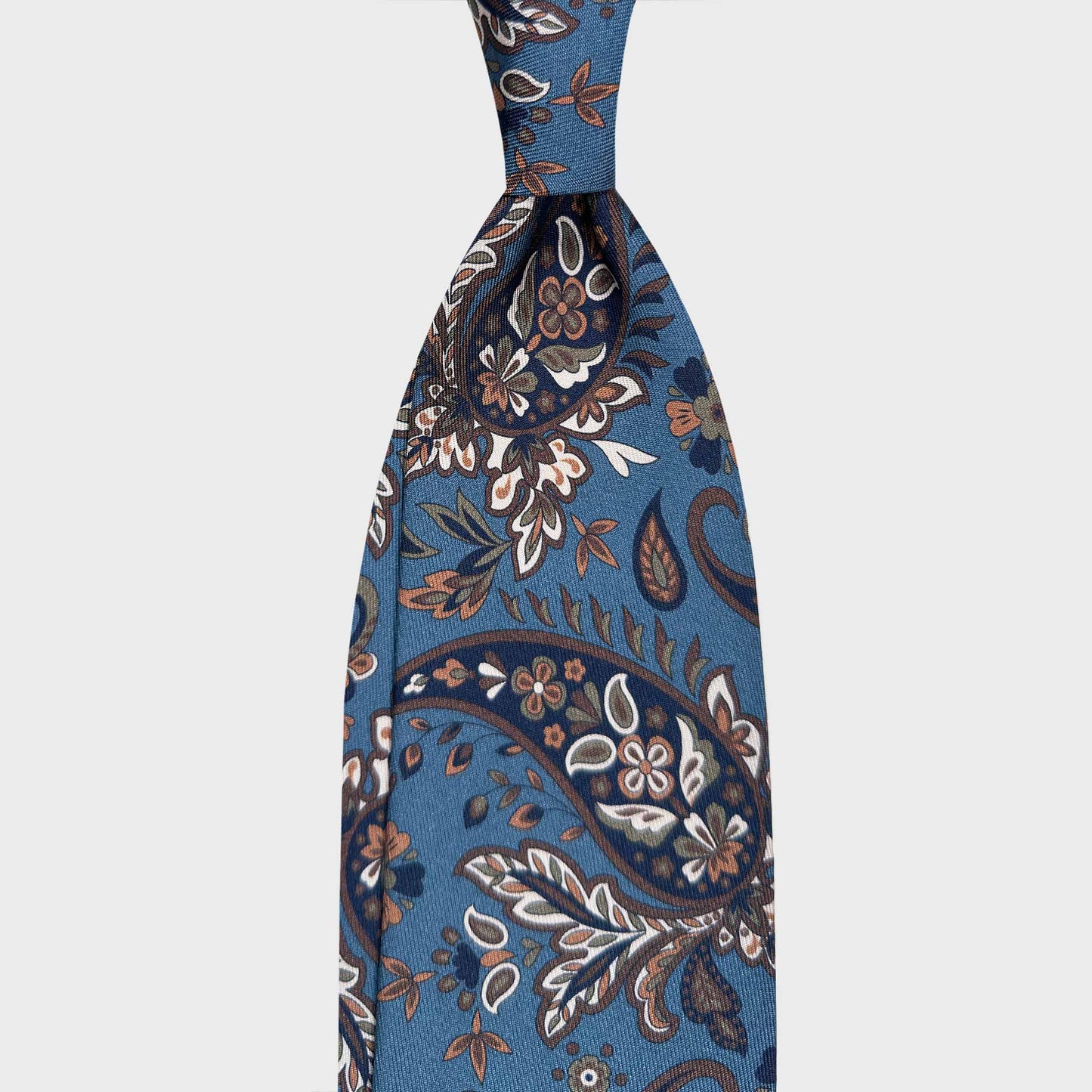 Cerulean Blue Silk Tie Liberty Botanical Paisley Design. Silk tie featuring a refined Liberty botanical paisley on cerulean blue background with navy and ivory white. Handmade in Italy for timeless sartorial elegance.