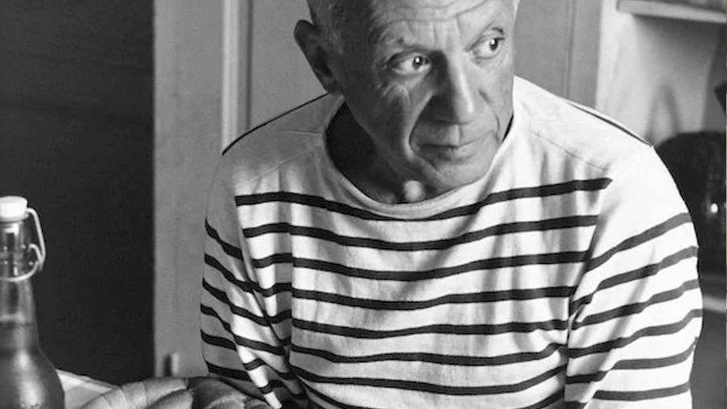 Pablo Picasso wearing the iconic French marinière striped shirt, inspiration behind timeless men's knitwear style.